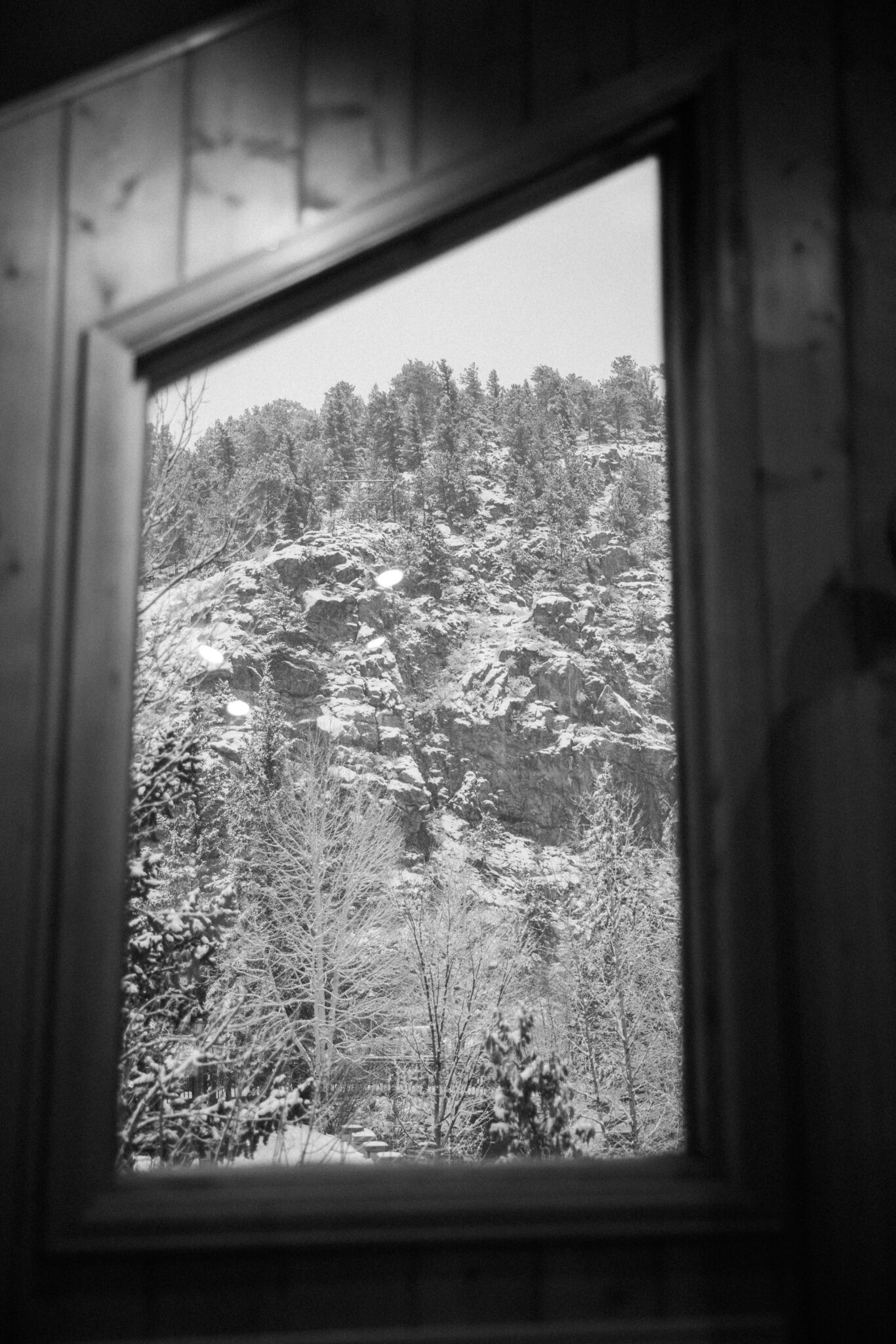 looking out at the snowy colorado mountains through a cafe window
