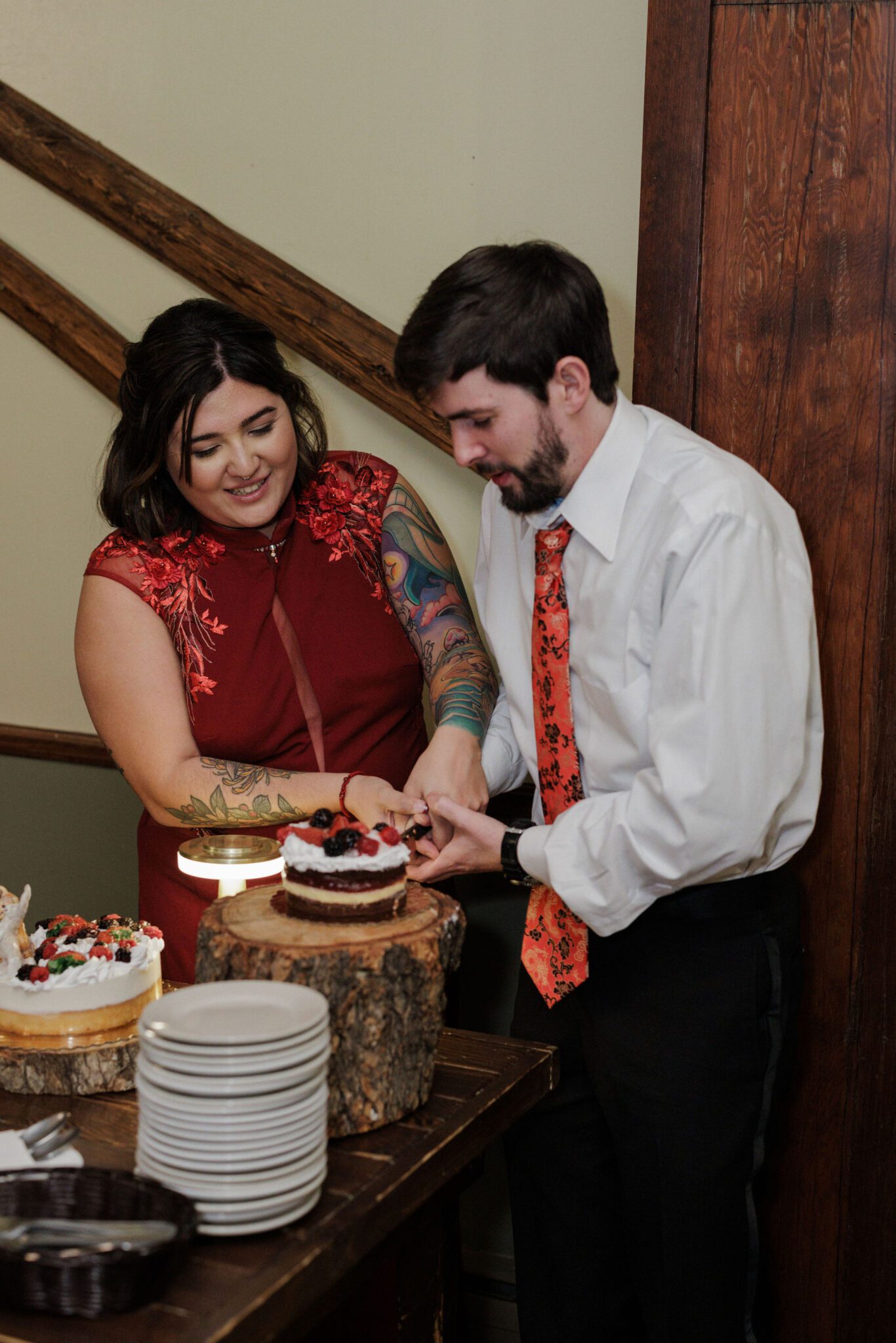 bride and groom cut winter elopement cake in colorado lodge