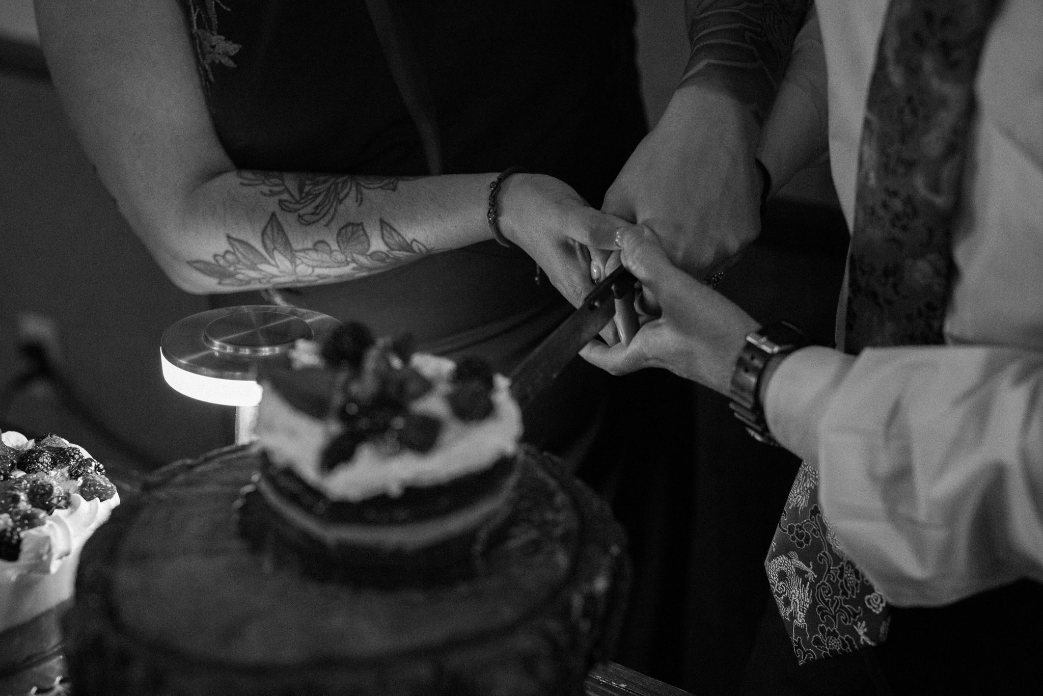 bride and groom cut into wedding cake at post-elopement dinner in estes park