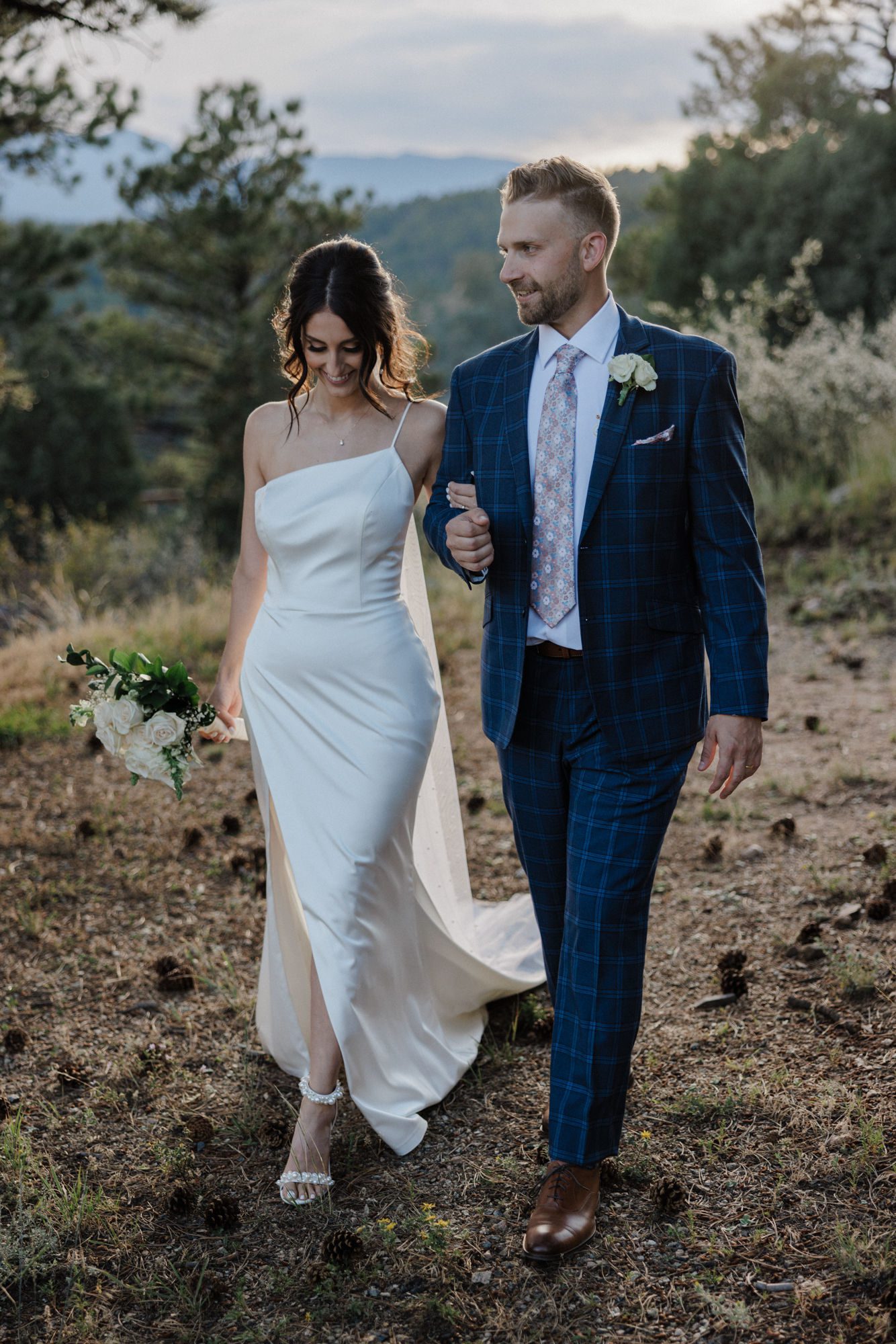 bride and groom walk on trail in colorado after mountain micro wedding.