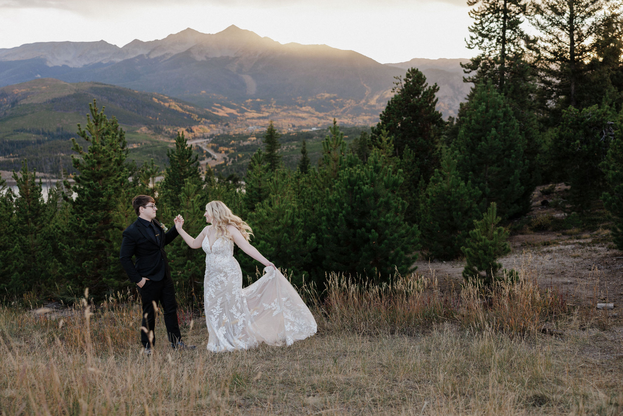 bride and groom dance in the mountains during fall wedding in colorado