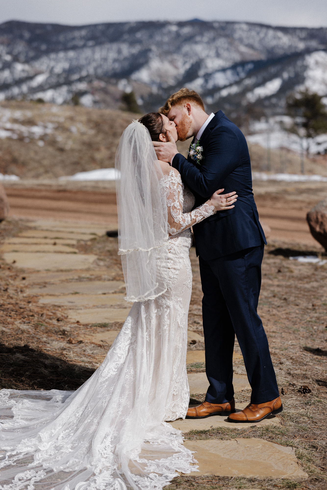 bride and groom kiss during wedding ceremony at colorado state park