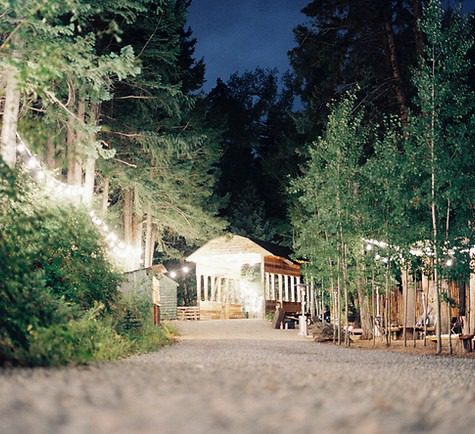 micro wedding ceremony set up with twinkle lights in the colorado forest