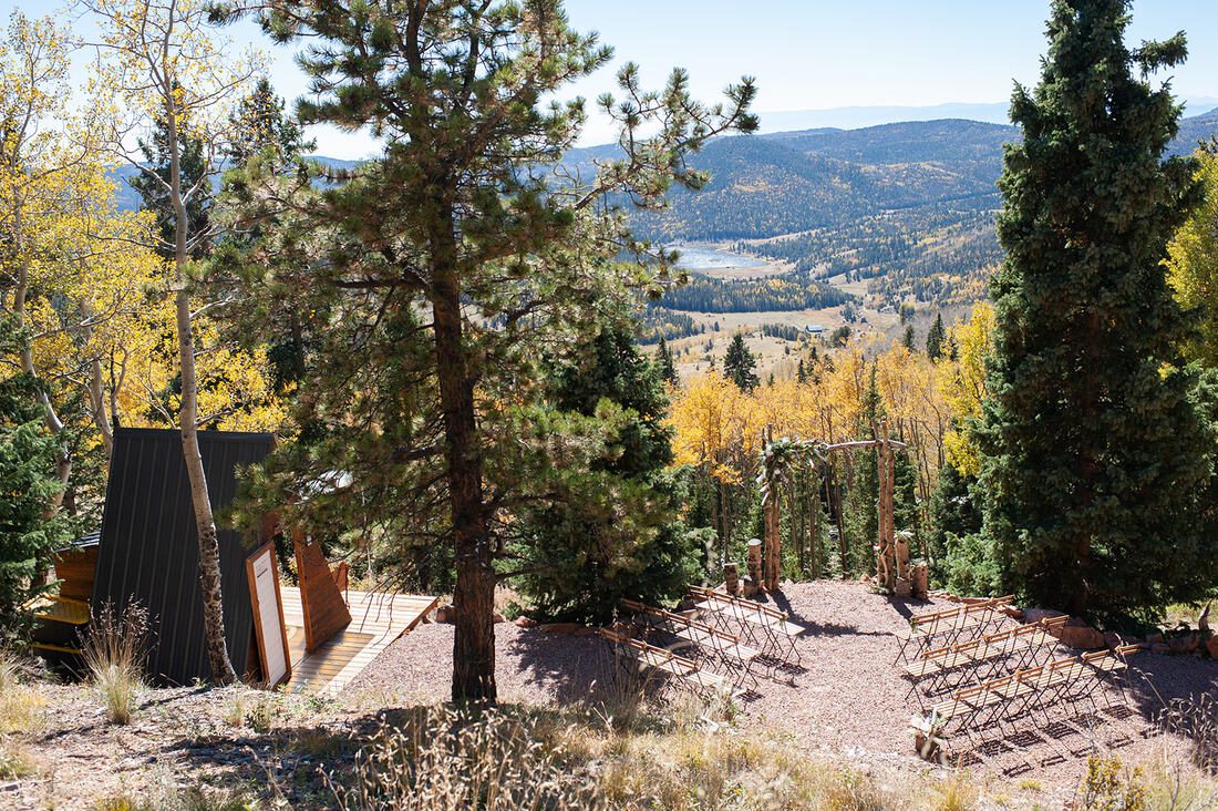 A-frame structure sits on a hill in the colorado forest, used for micro weddings and elopements