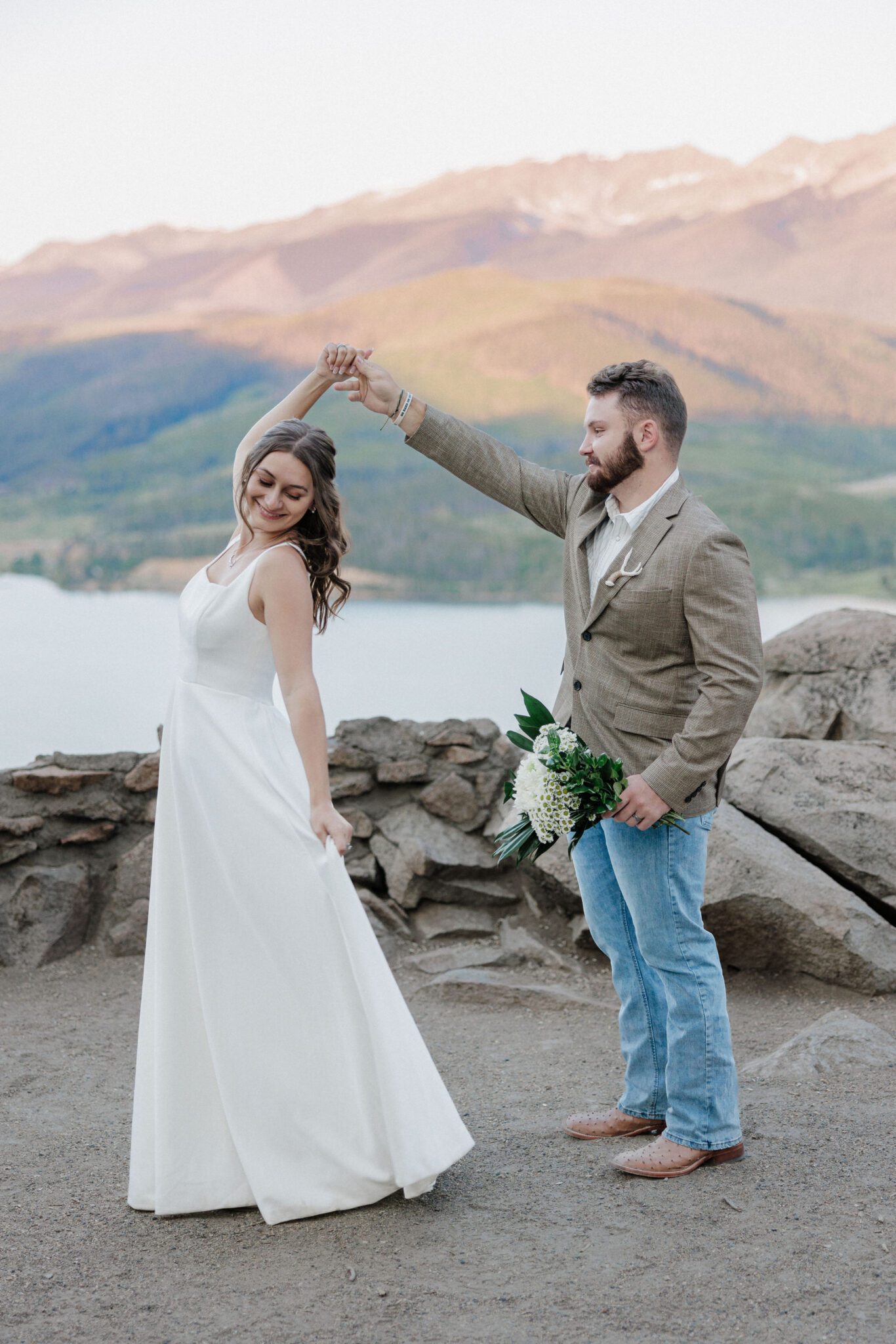 groom twirls bride during summer elopement wedding in colorado