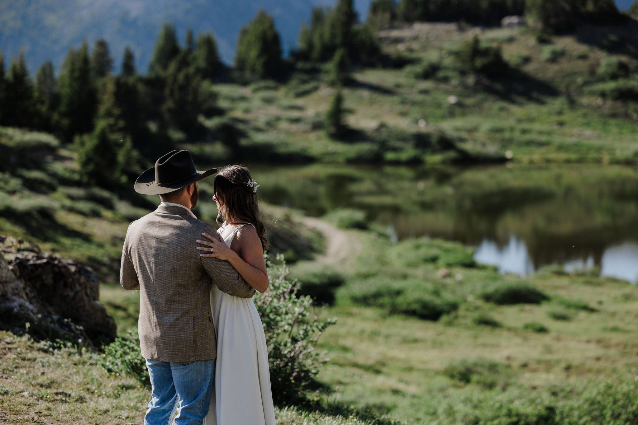 bride and groom dance during their mountain lake wedding in colorado