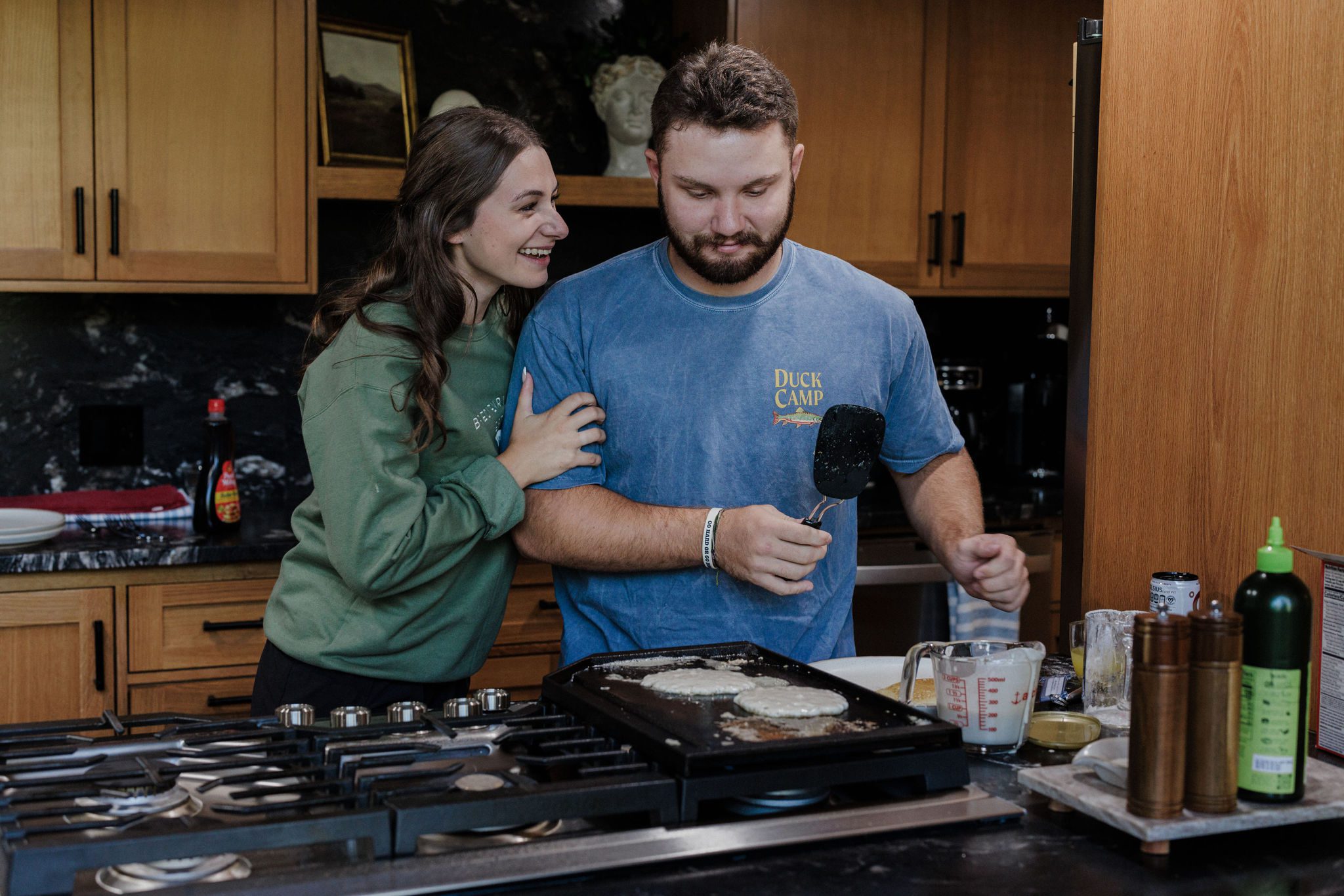 bride and groom make pancakes after summer elopement in colorado
