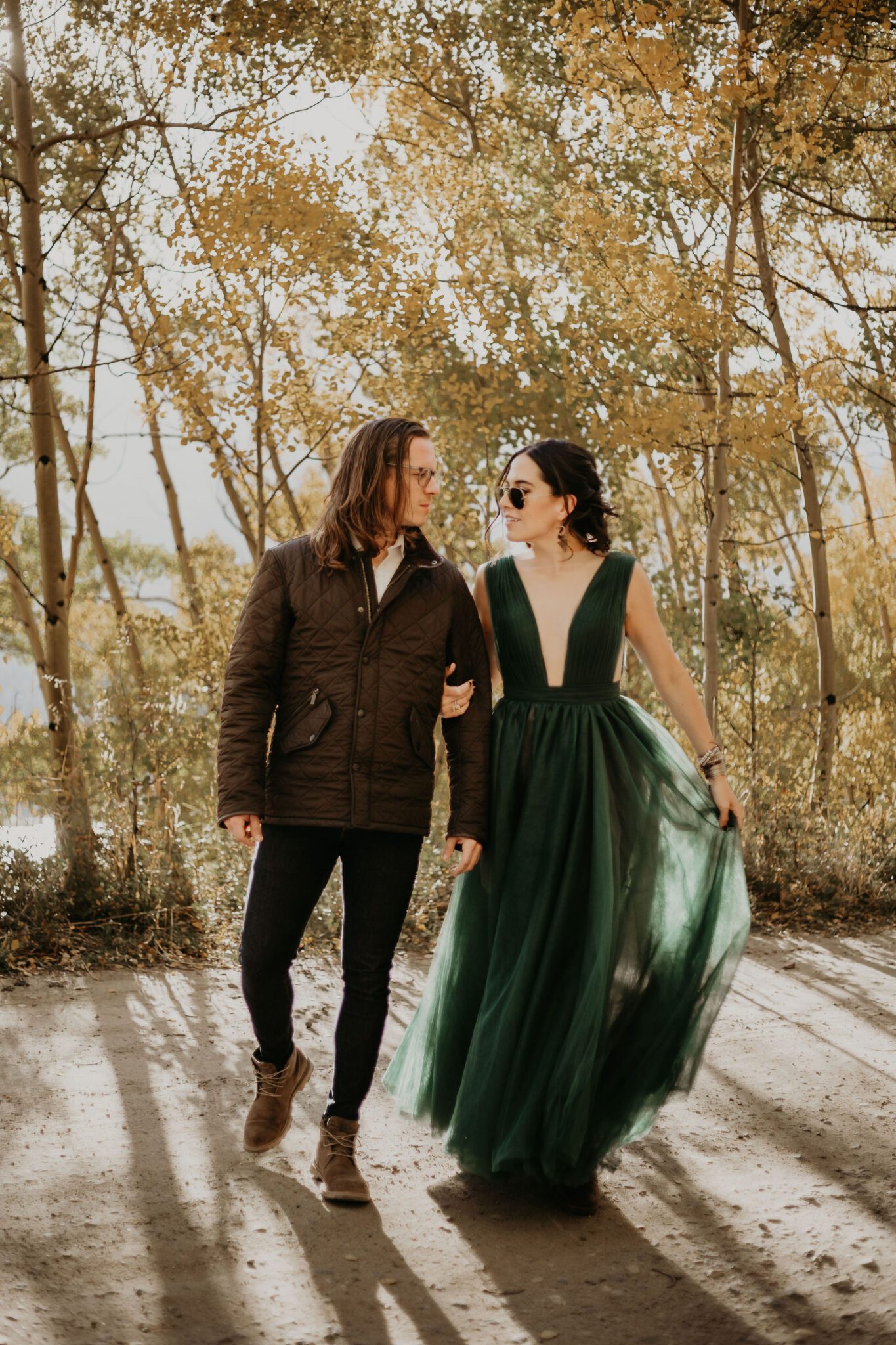 bride and groom pose for photographer at colorado fall wedding vanue