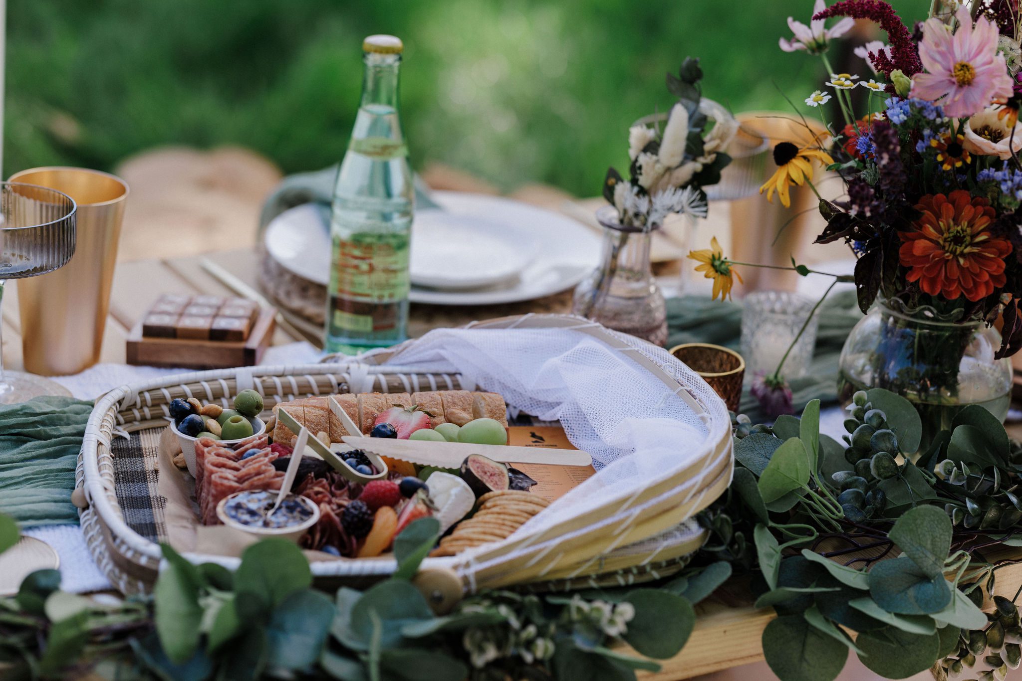 picnic is set up for a colorado lake wedding by the lake in the mountains