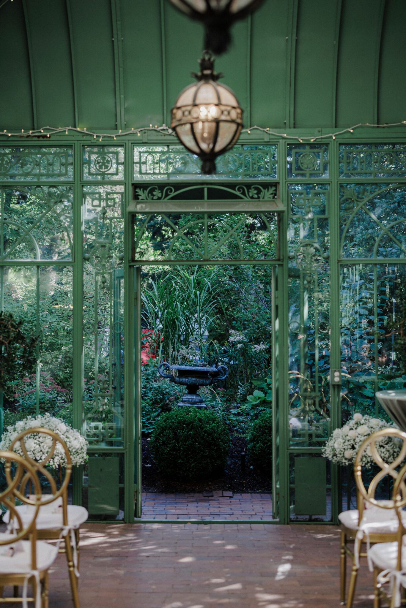 vibrant greenery blooms outside of ceremony space at summer wedding venue in colorado, the denver botanic gardens