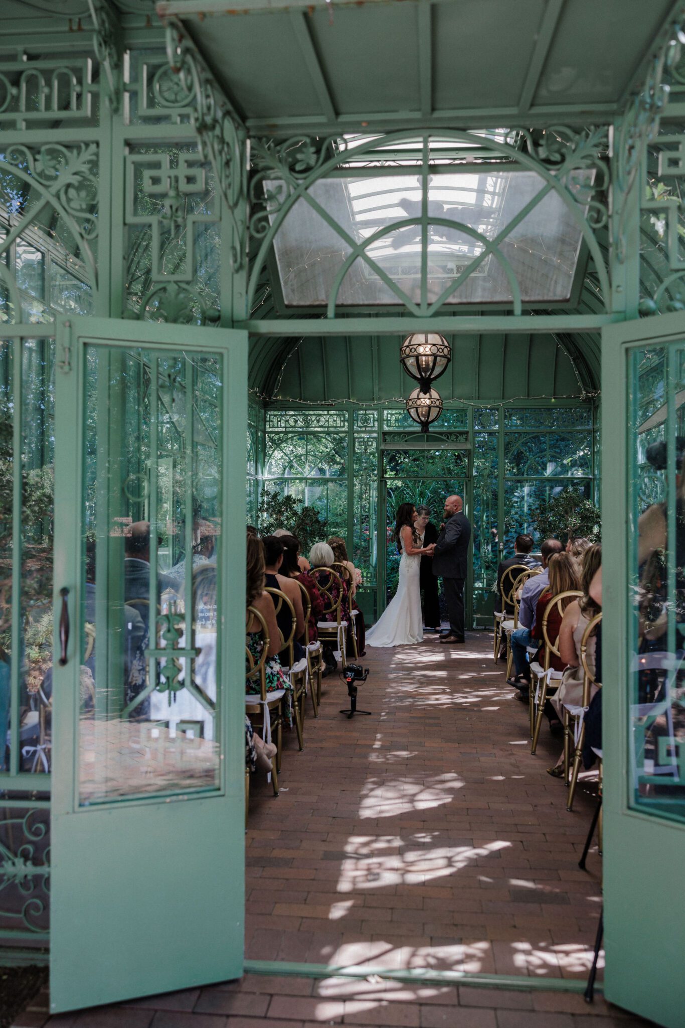 bride and groom say wedding vows in summer wedding venue, the denver botanic gardens