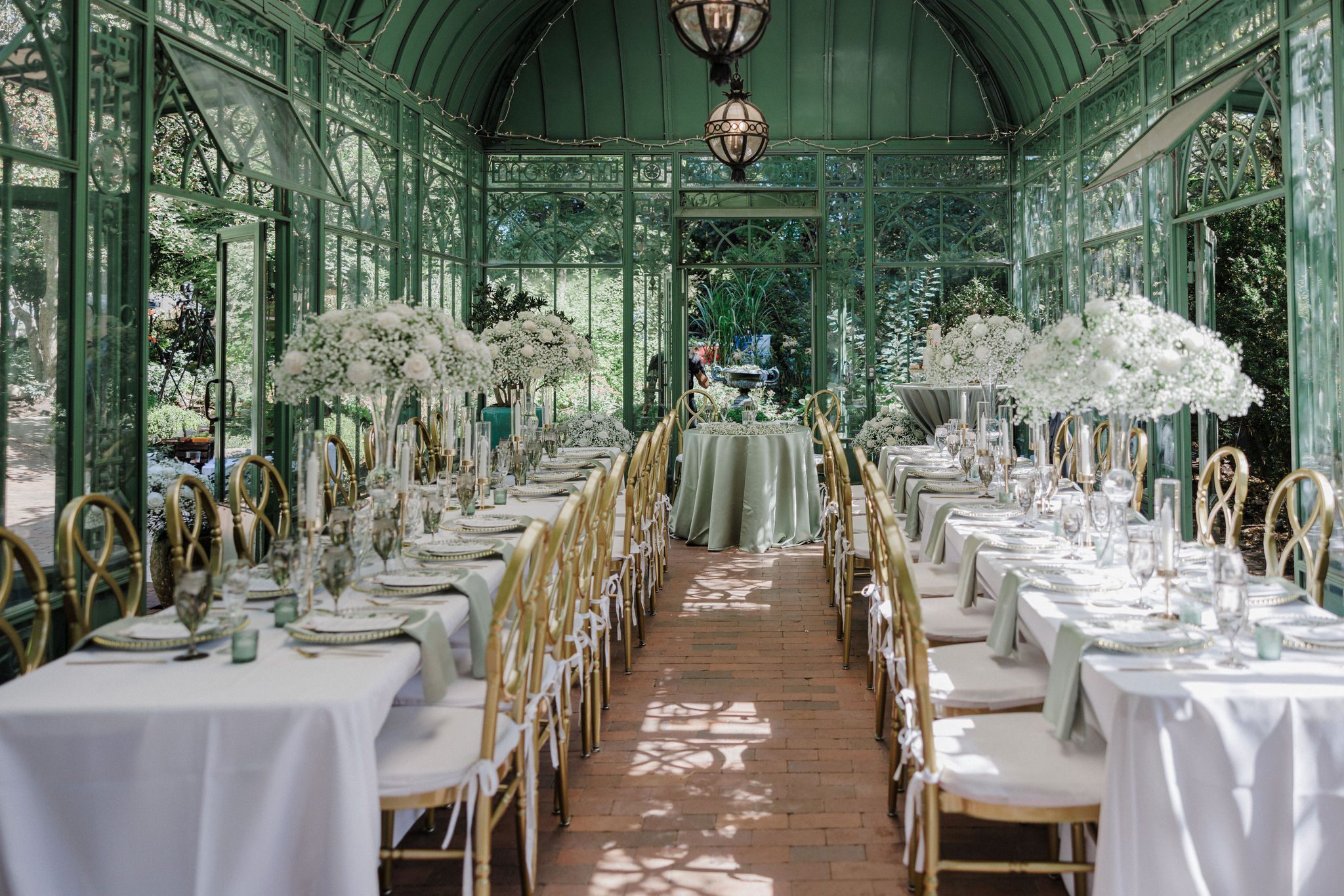 two long rows of tables set up for micro wedding reception dinner at the denver botanic gardens in the summer