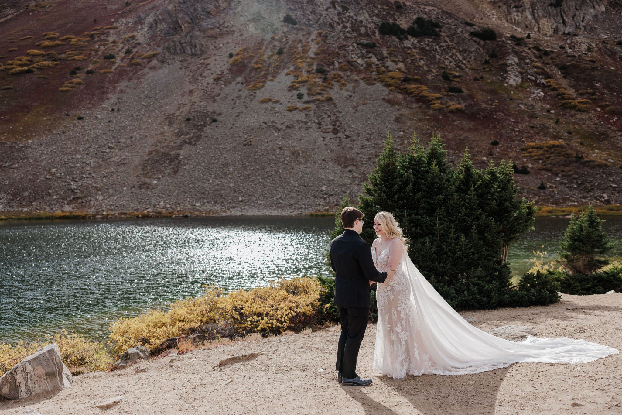 bride and groomsay wedding vows at pass lake in breckenridge during mountain ewedding