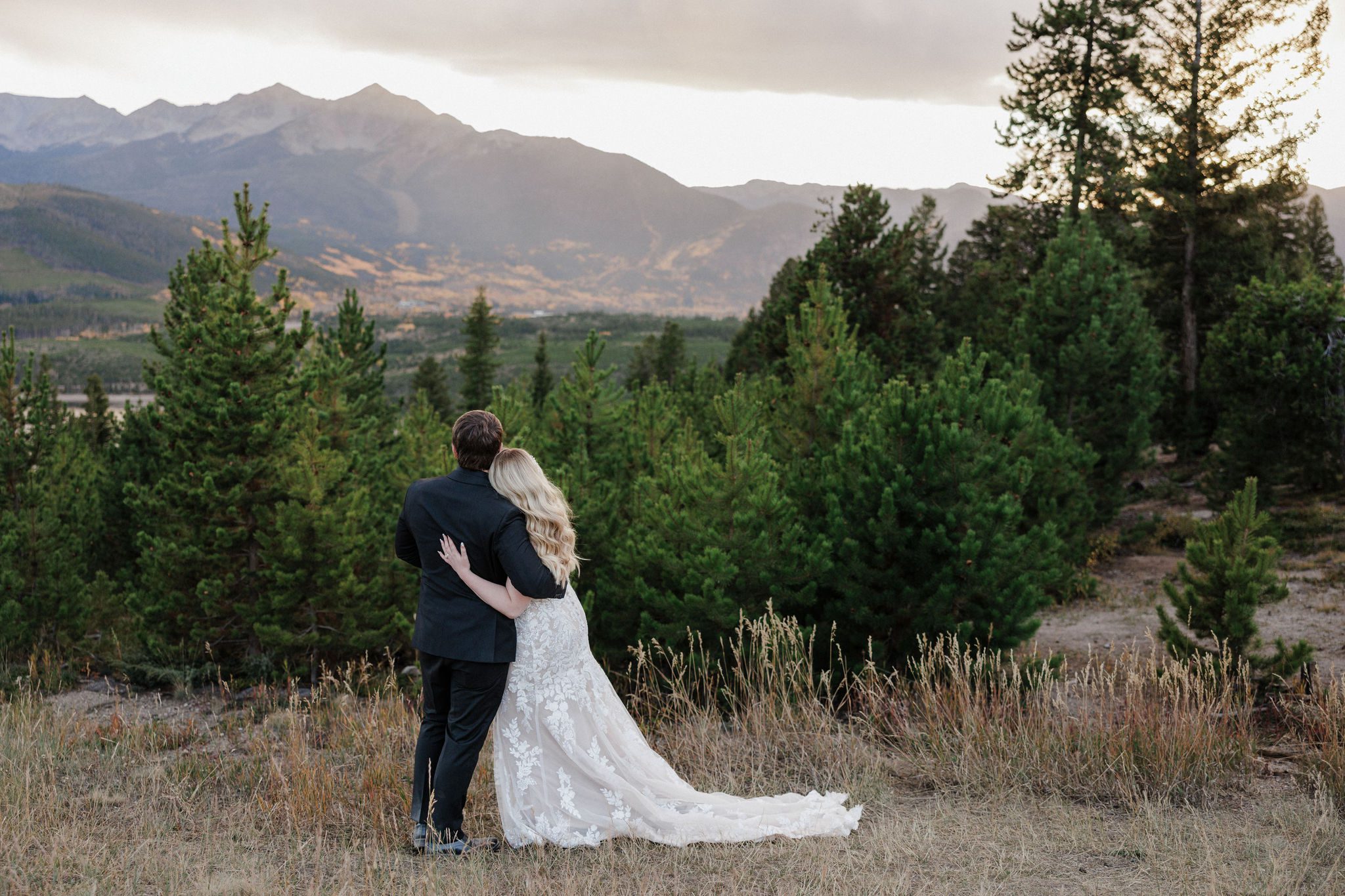 bride leans on grooms shoulder during fall wedding photos in breckenridge