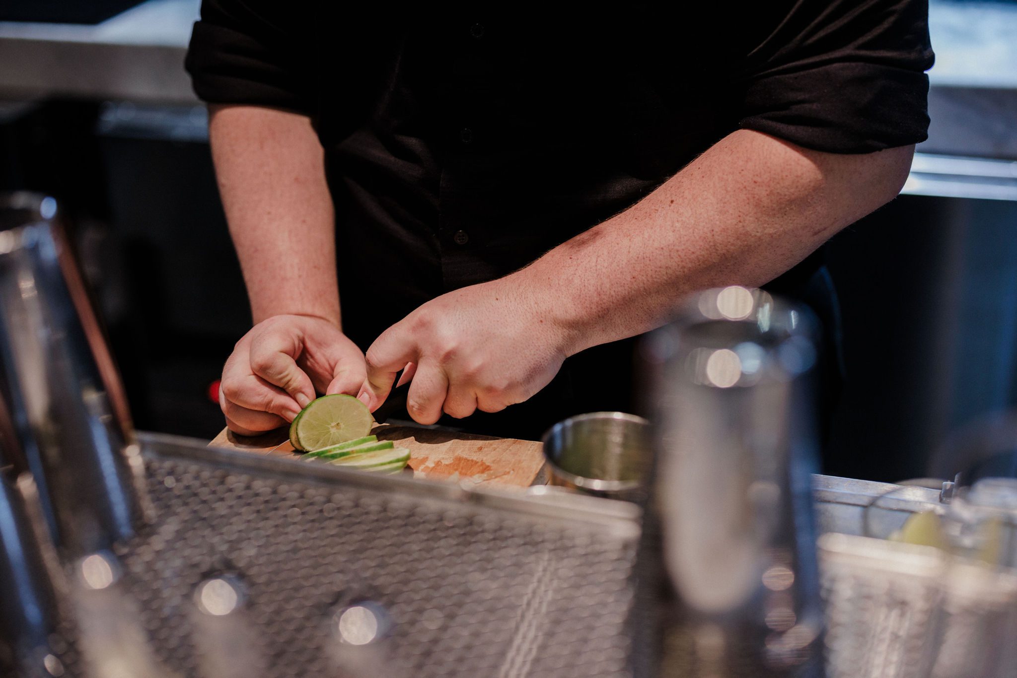 bartender cuts limes at denver micro wedding venue, the ramble hotel