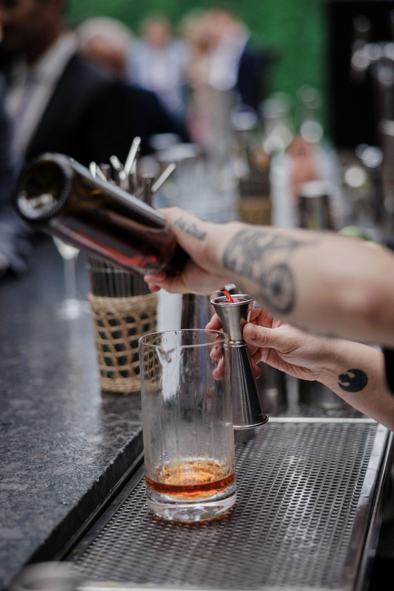 bartender pours a custon drink at denver micro wedding venue, the ramble hotel