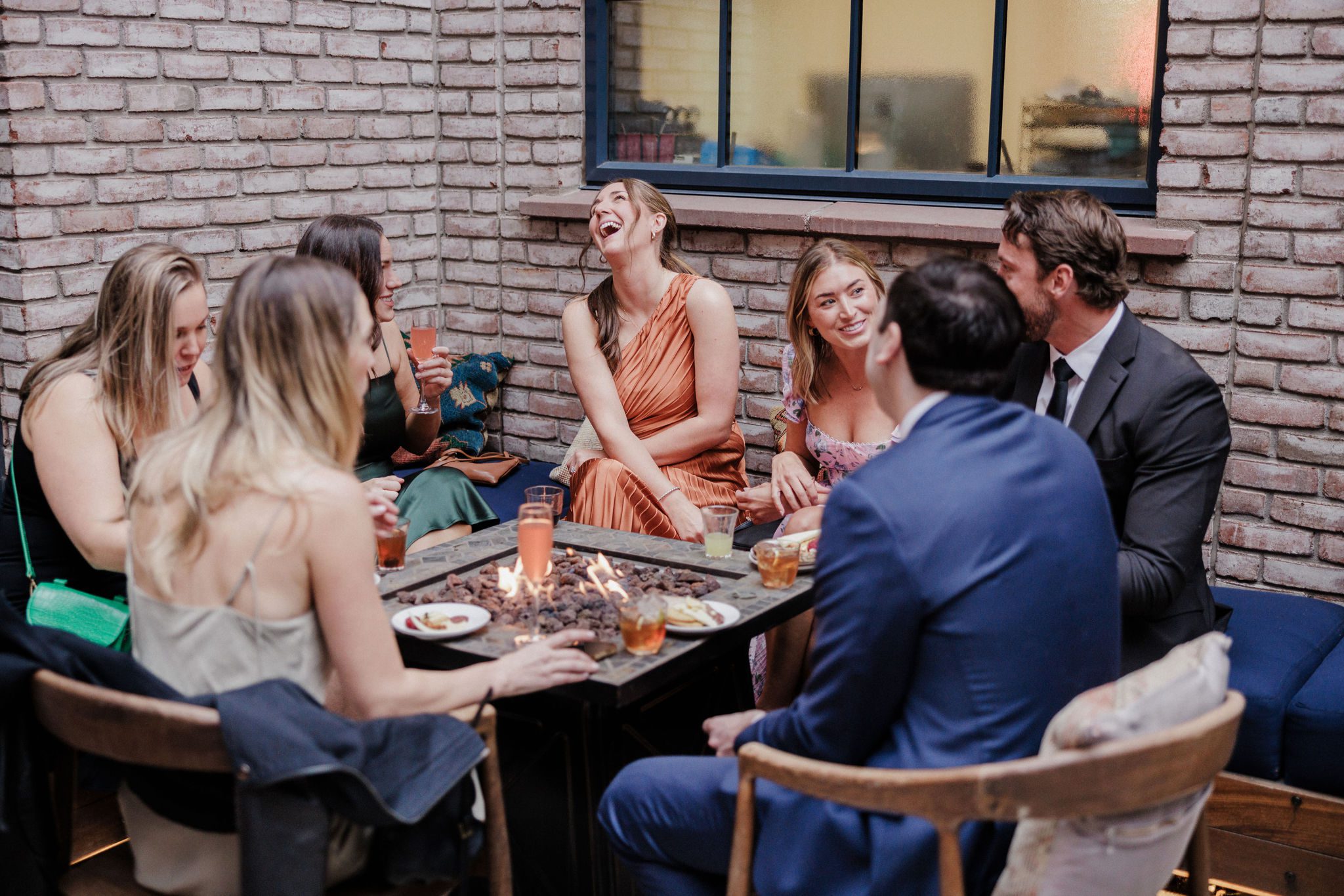 wedding guests sit around table at the ramble hotel during cocktail hour