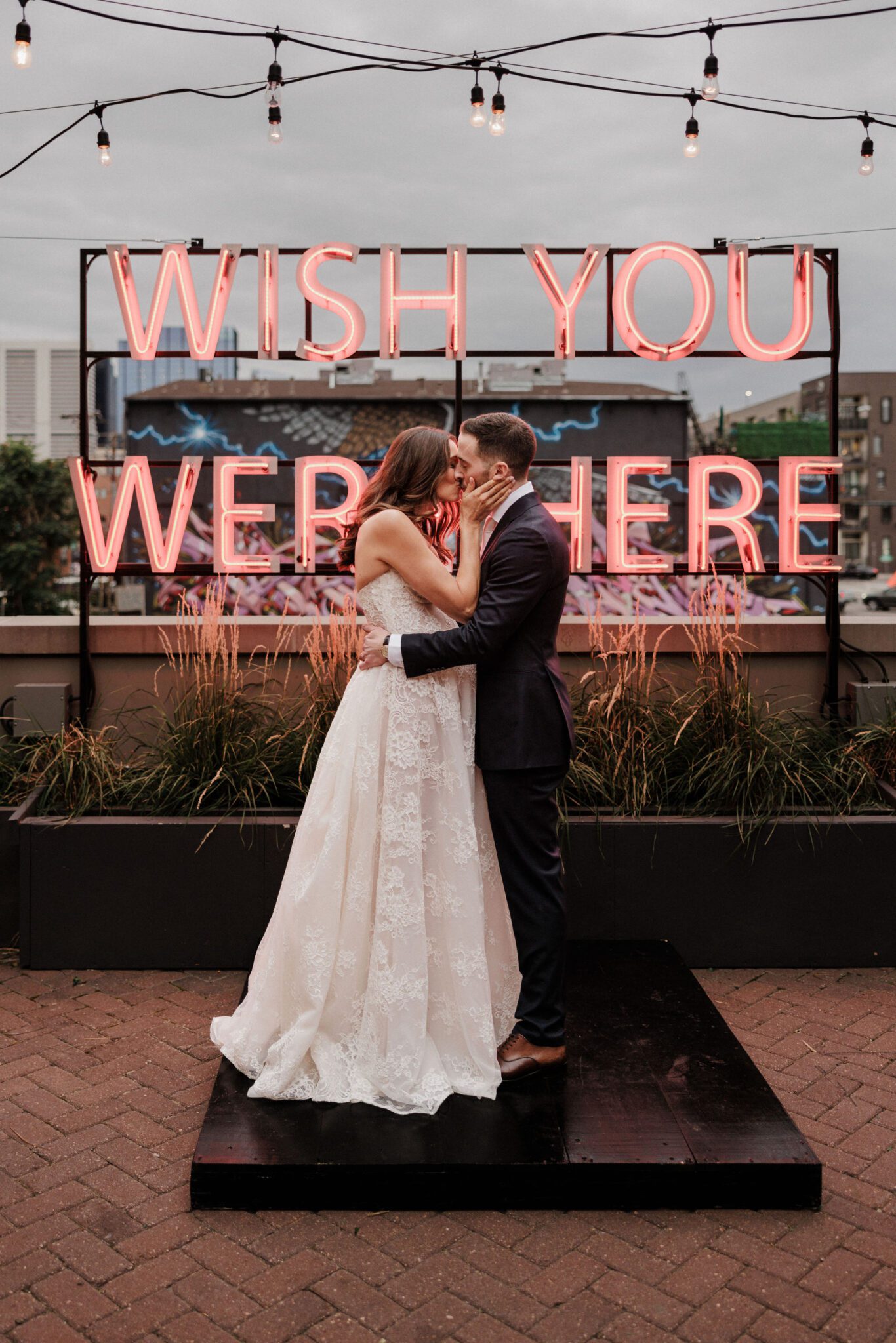 bride and groom kiss on the rooftop of the ramble hotel during denver micro wedding