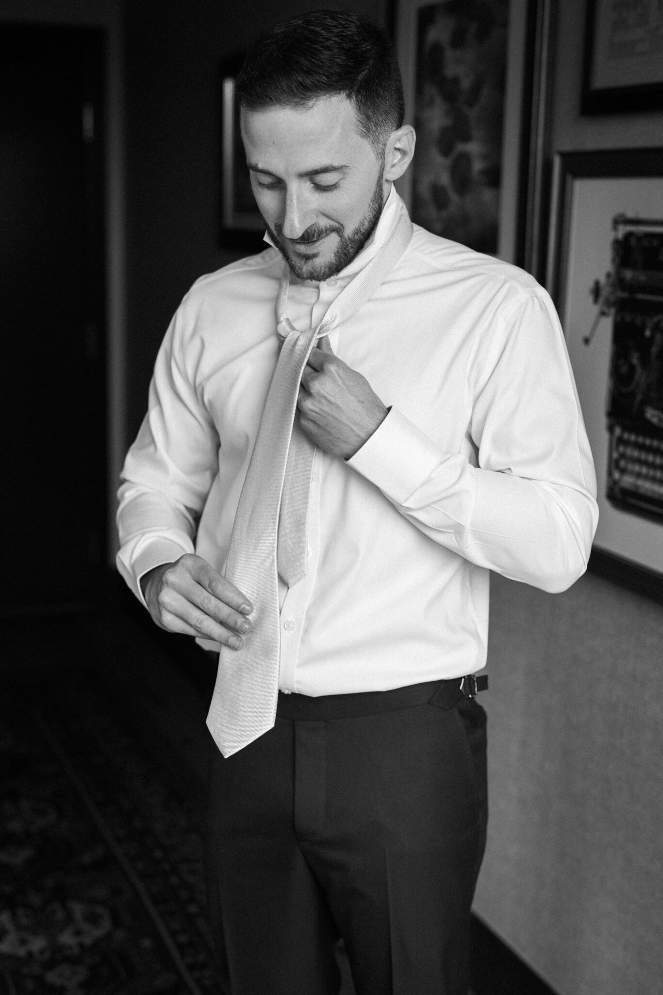 groom ties tie before getting married at the denver micro wedding wedding venue, the ramble hotel