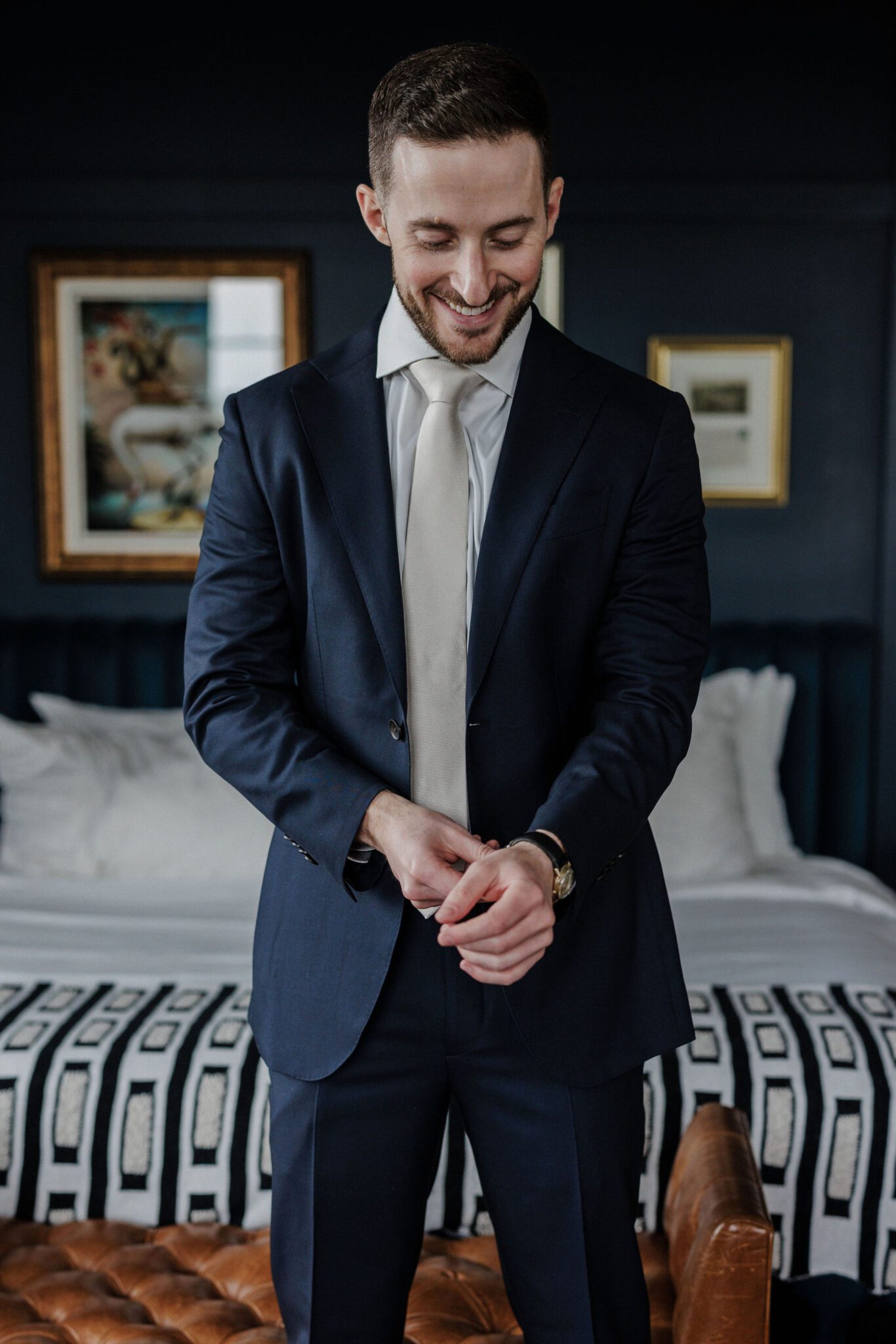 groom puts suit jacket on in denver micro wedding wedding venue, the ramble hotel, before ceremony