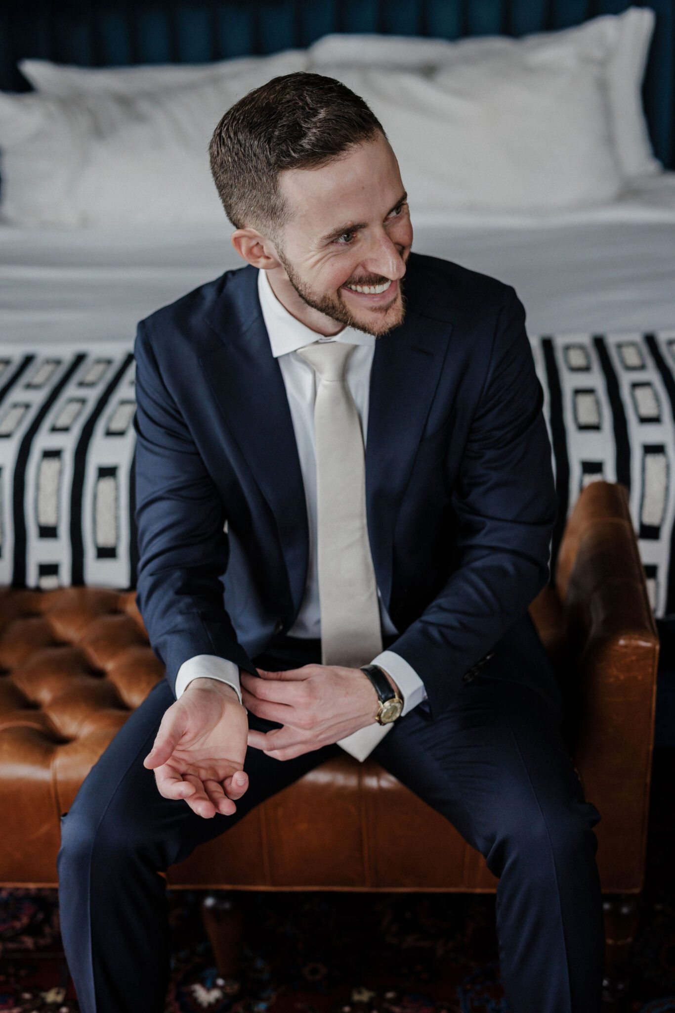 groom poses for micro wedding and elopement photographer at the ramble hotel in denver