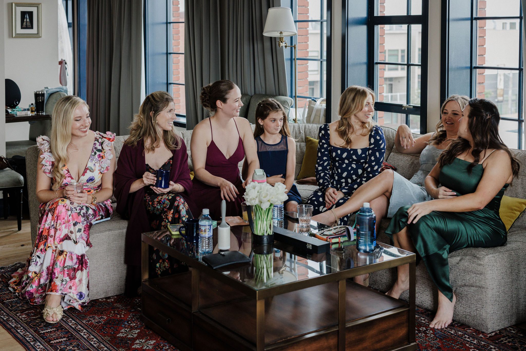 bridesmaids sit on couch before wedding ceremony at the ramble hotel