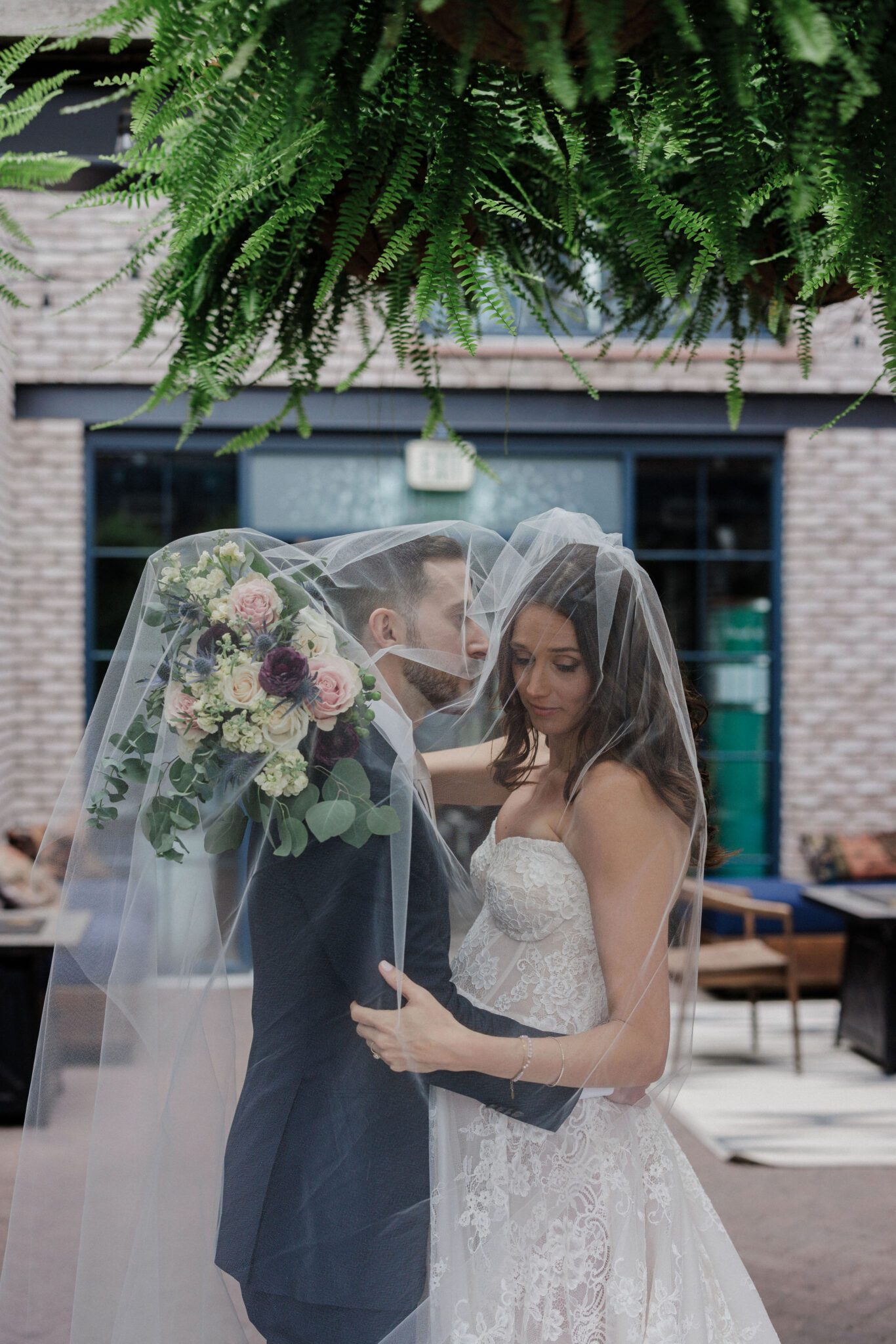 bride and groom take photos on rooftop of denver micro wedding venue, the ramble hotel