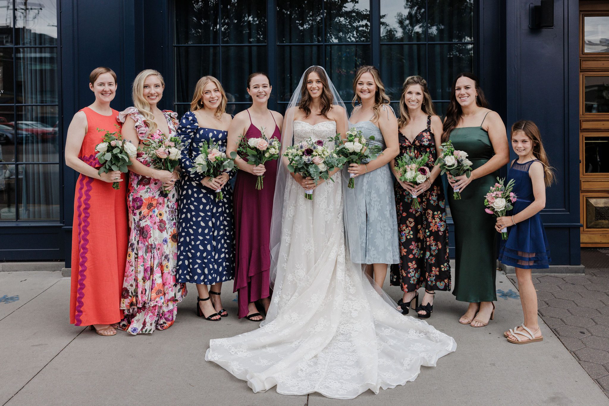 bride and bridesmaids stand in front of the ramble hotel, a denver micro wedding venue downtown