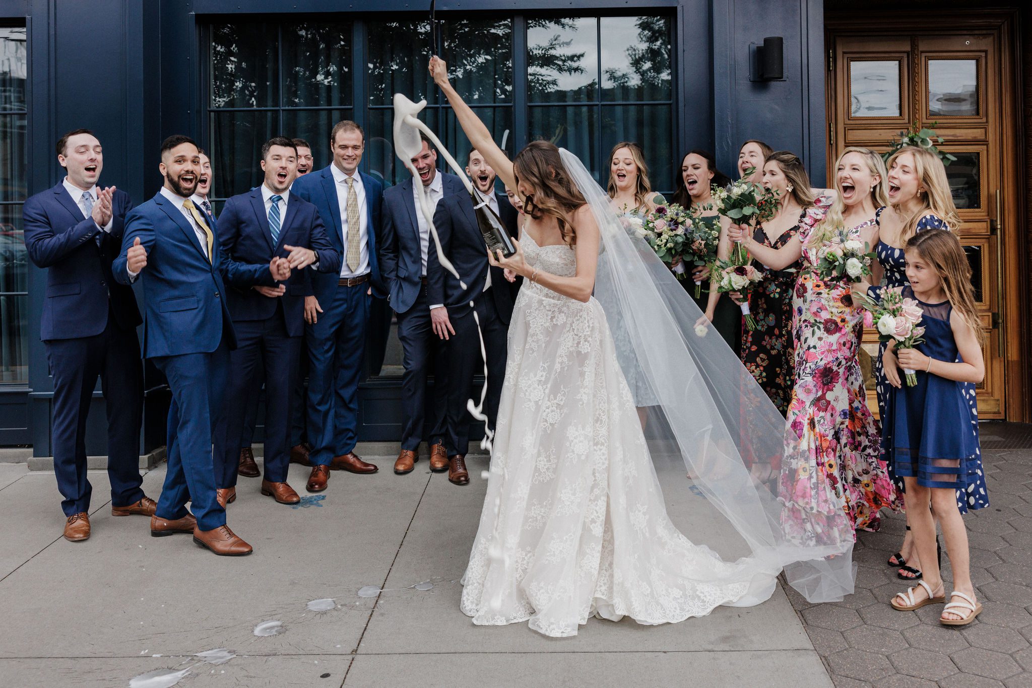 bride sabers champagne before wedding ceremony at the ramble hotel