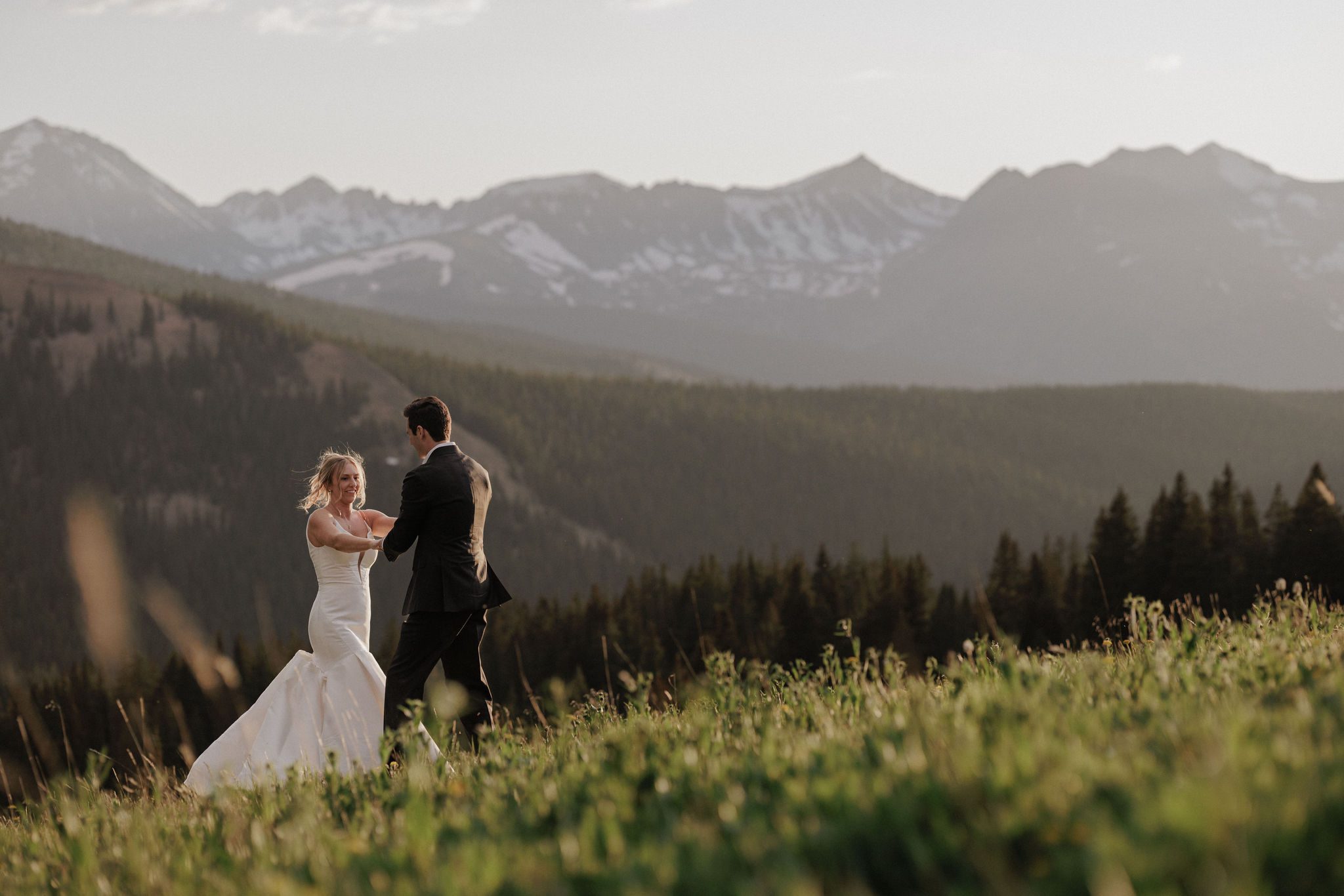 bride and groom dance on the mountainside during their summer elopement at boreas pass