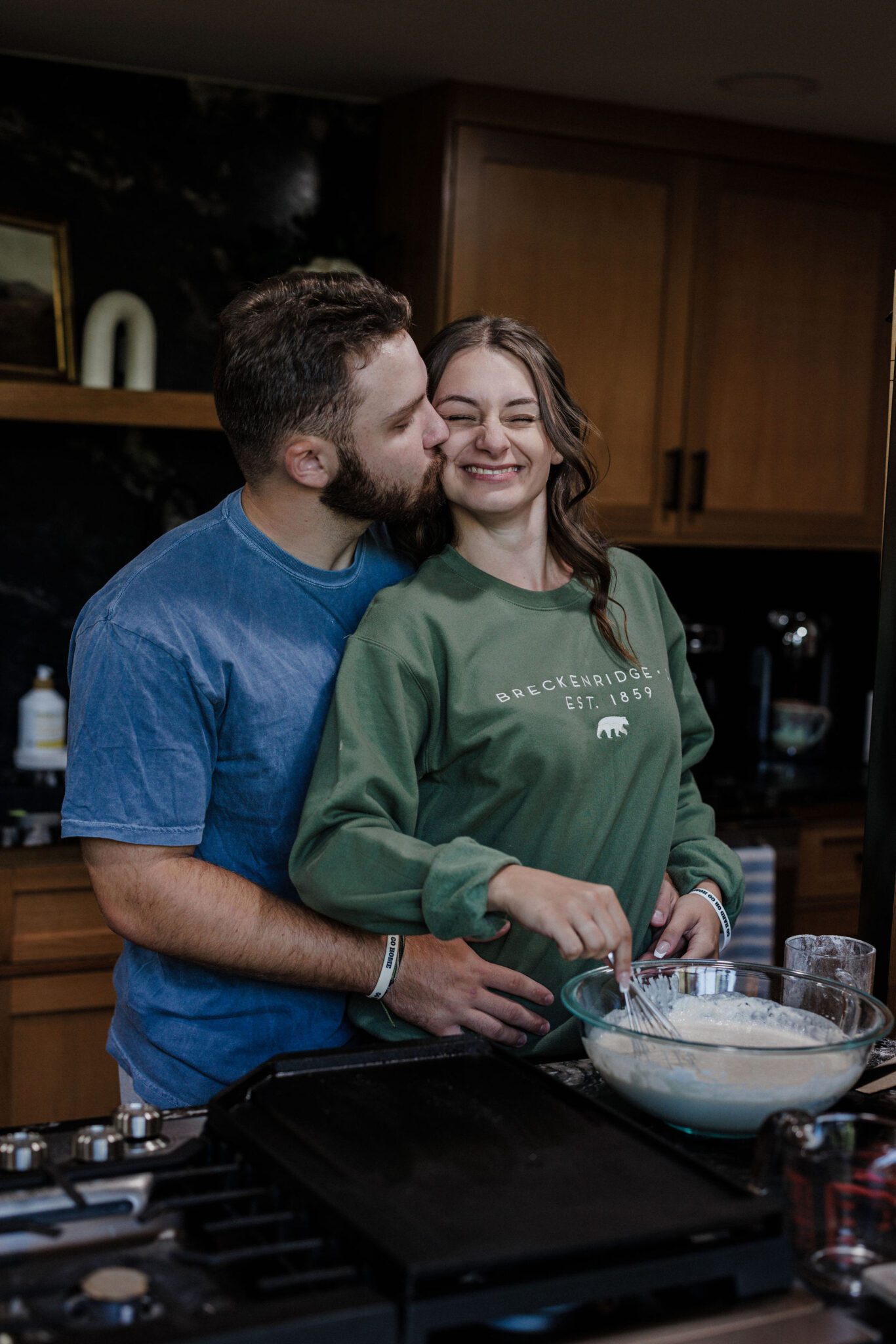 bride and groom make pancakes in their airbnb after their elopement