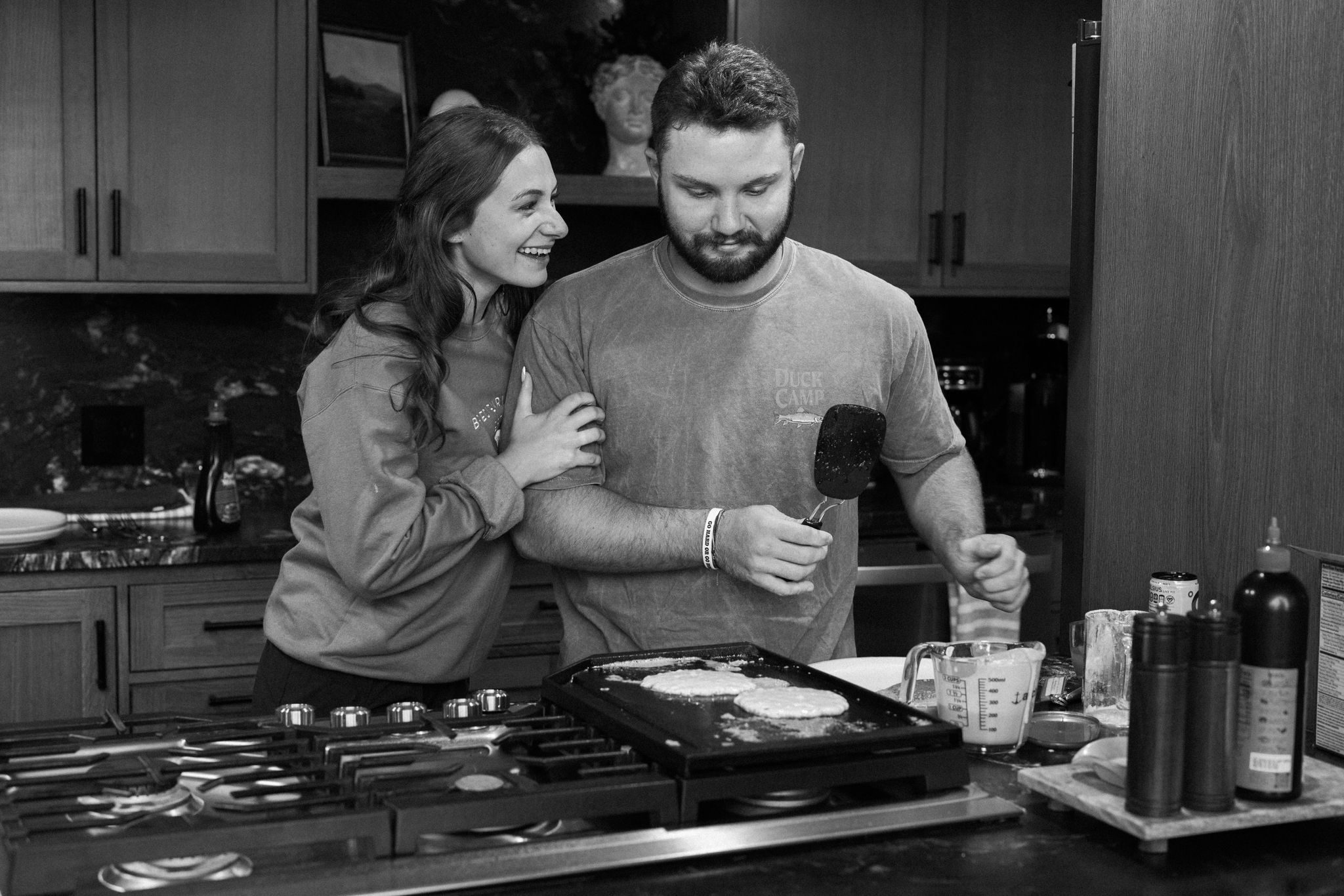 bride and groom make pancakes after their elopement ceremony