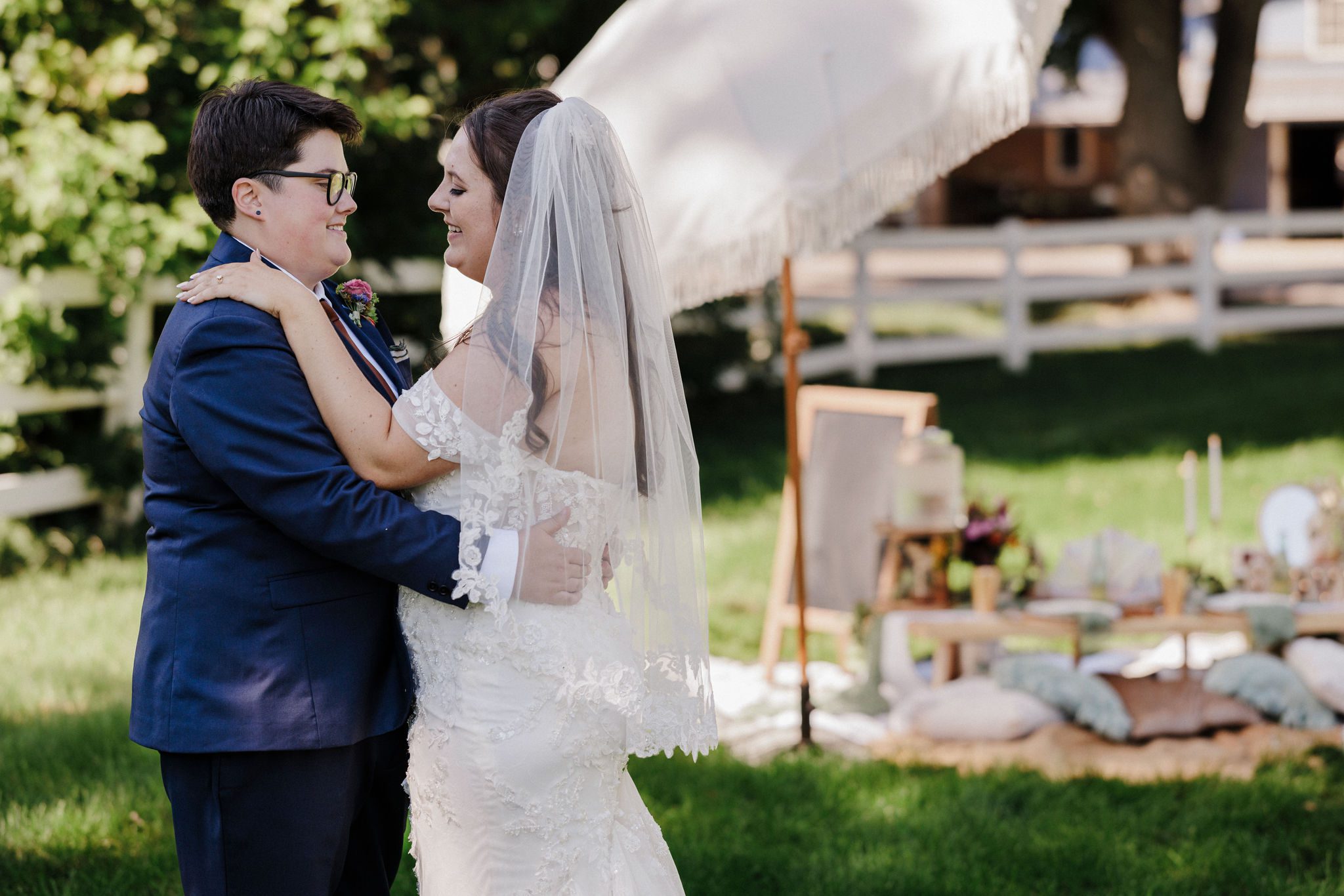 two brides share a first dance in their backyard