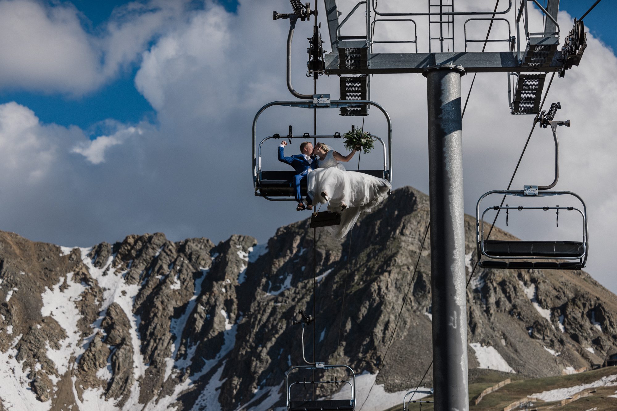 Bride and groom embrace the new meaning of elopement by riding a ski lift