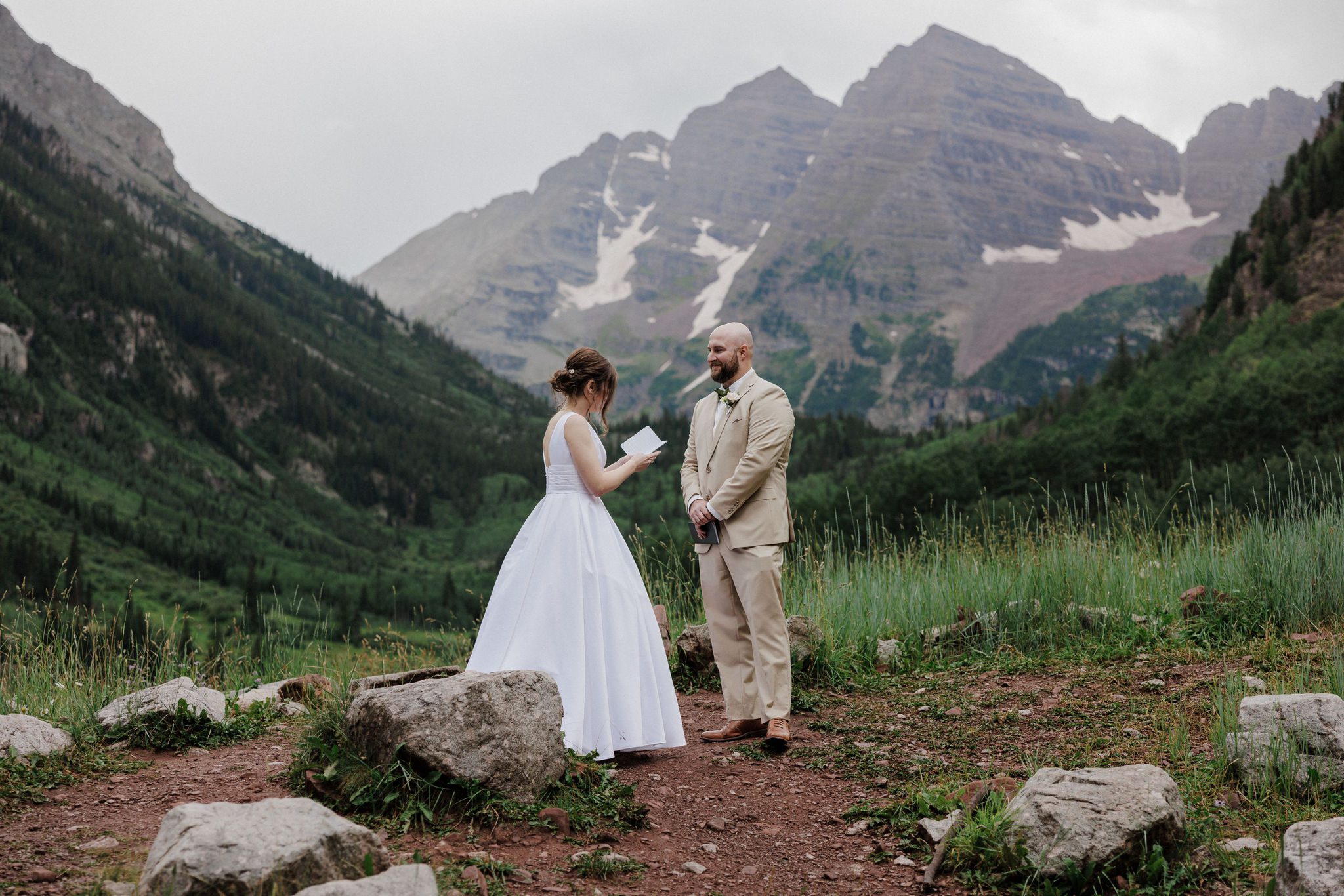 bride reads wedding vows to groom while embracing the modern meaning of 'elope'