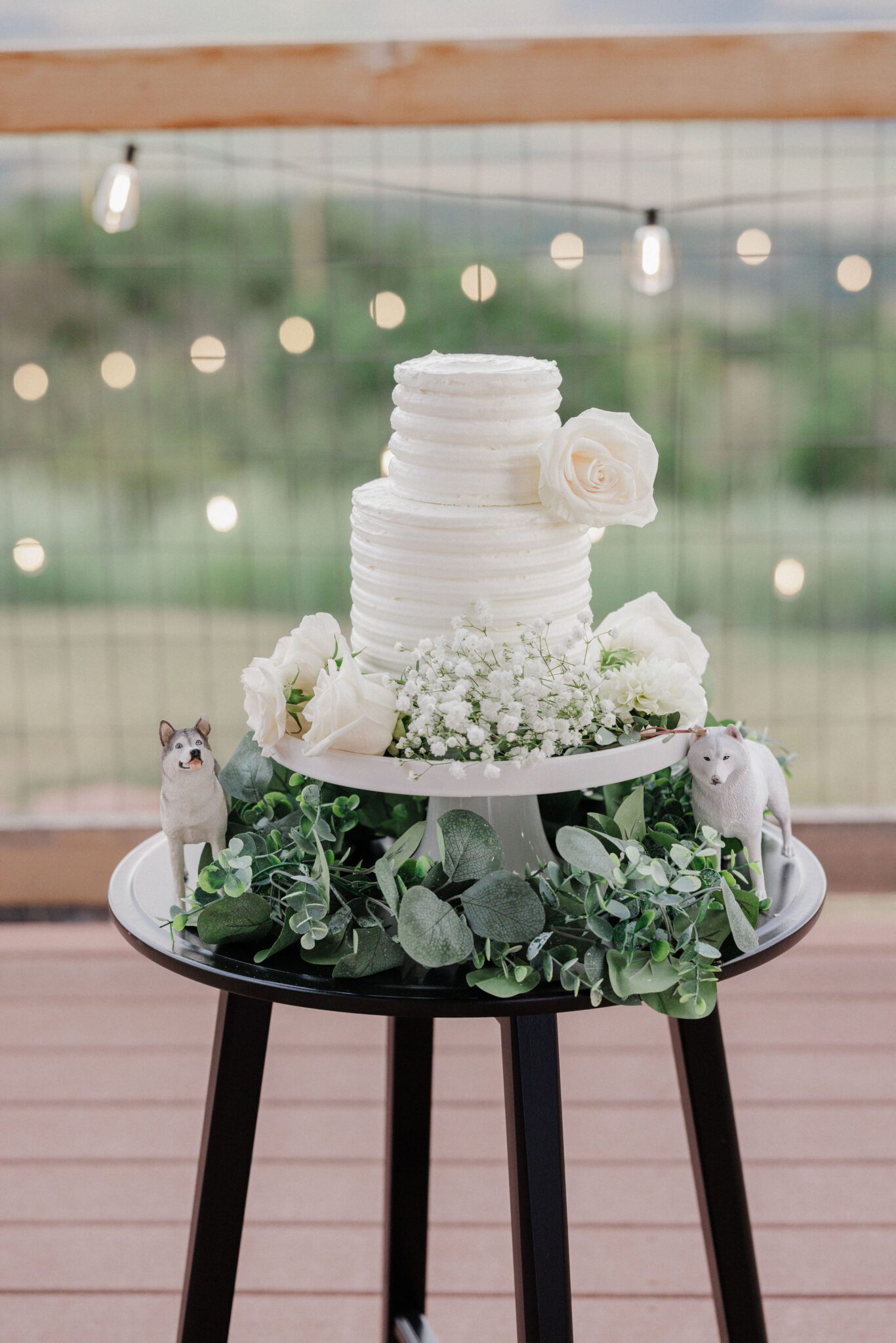wedding cake sits on the deck of an airbnb during a micro wedding