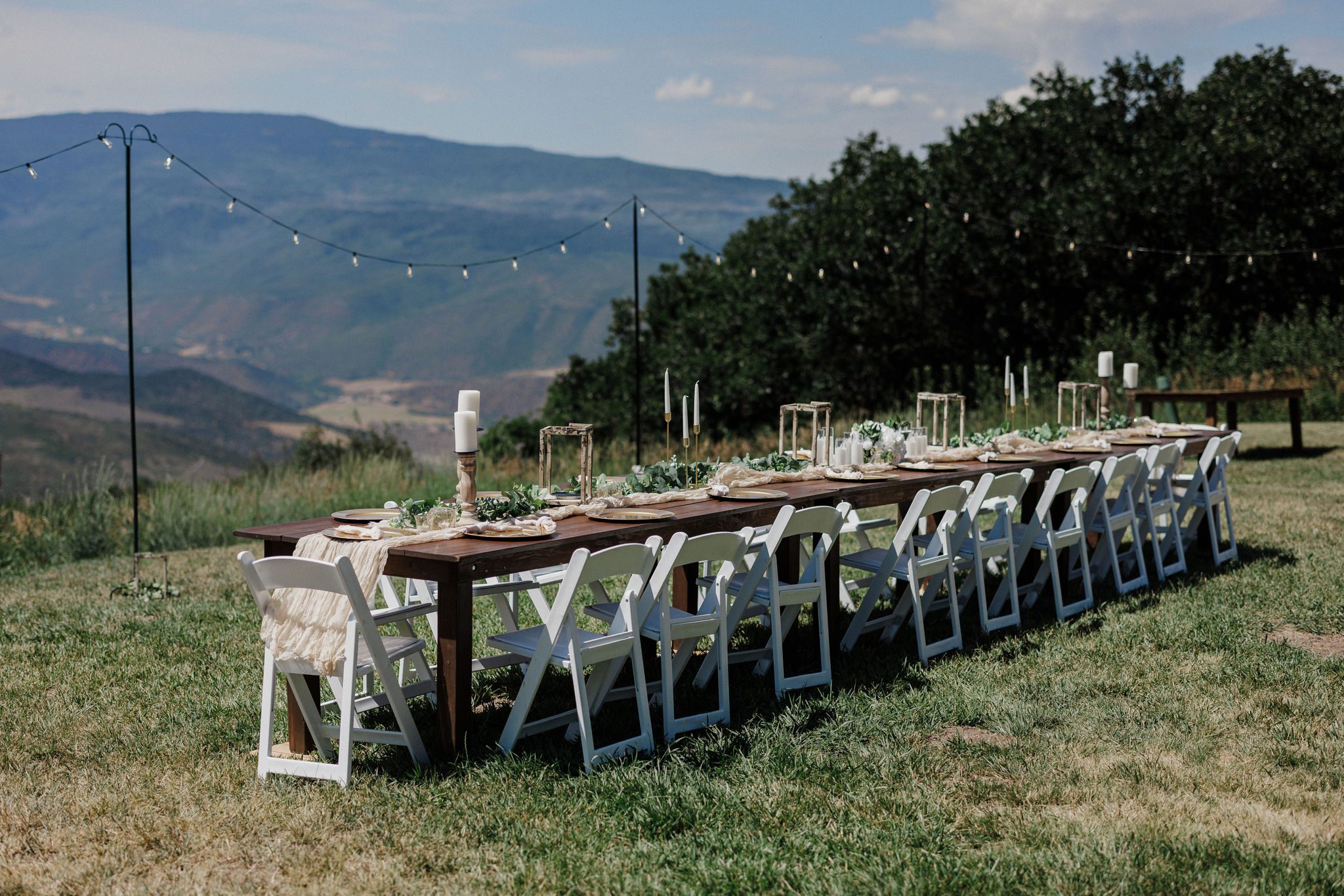 long family style dinner table set up in the backyard of an airbnb for a micro wedding reception