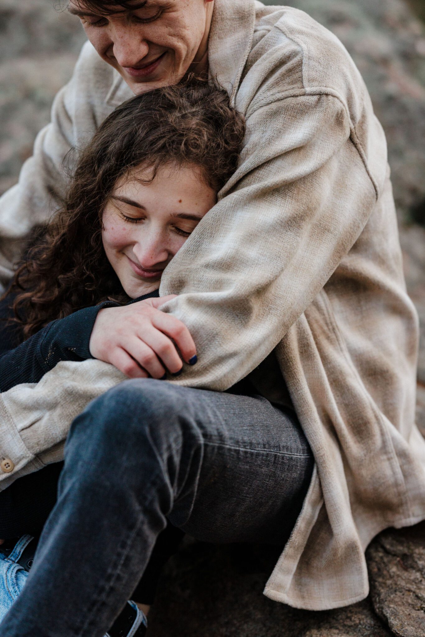 close up image of man and woman cuddling during colorado engagement photos in the mountains, after marriage proposal