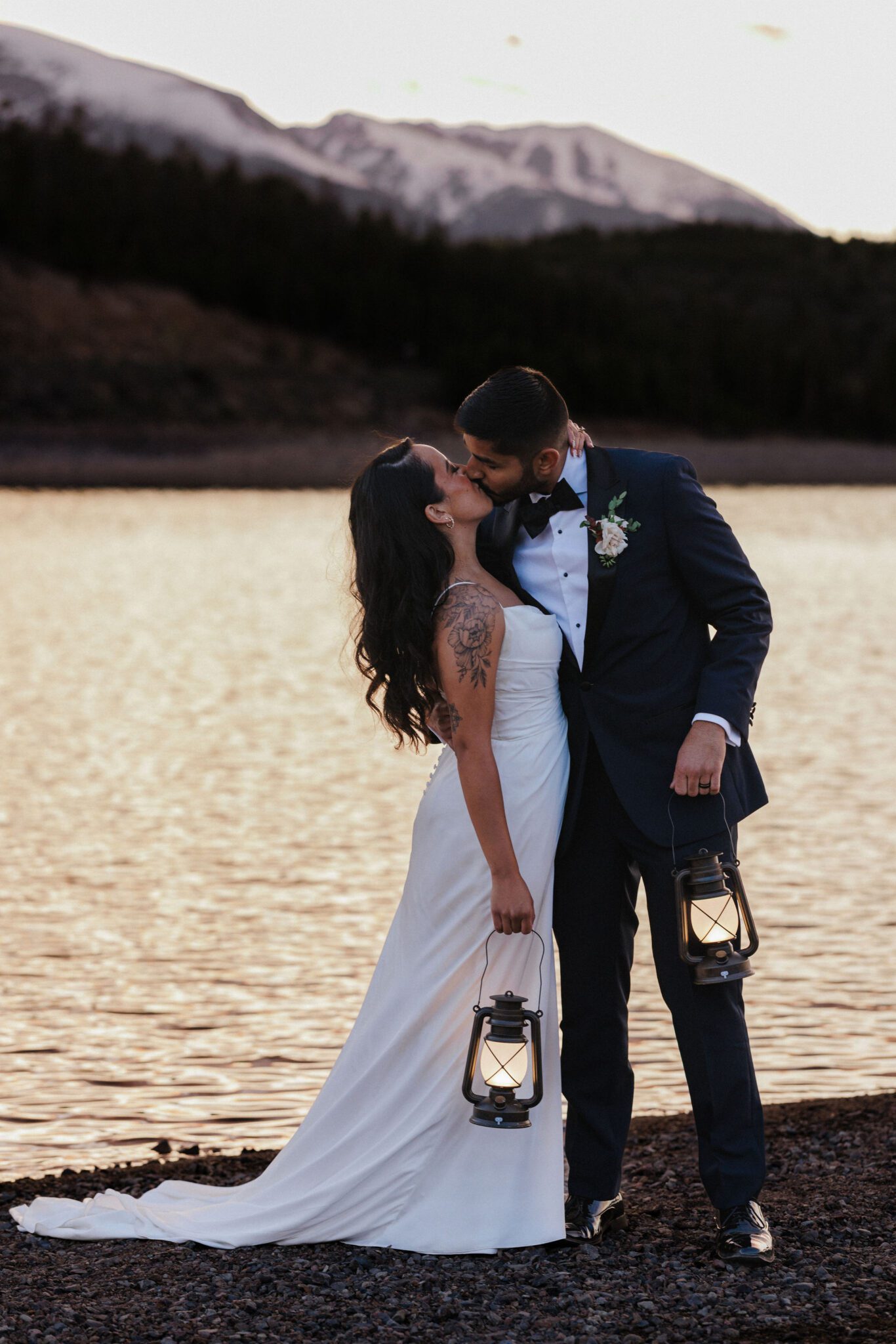 bride and groom kiss in front of lake dillon