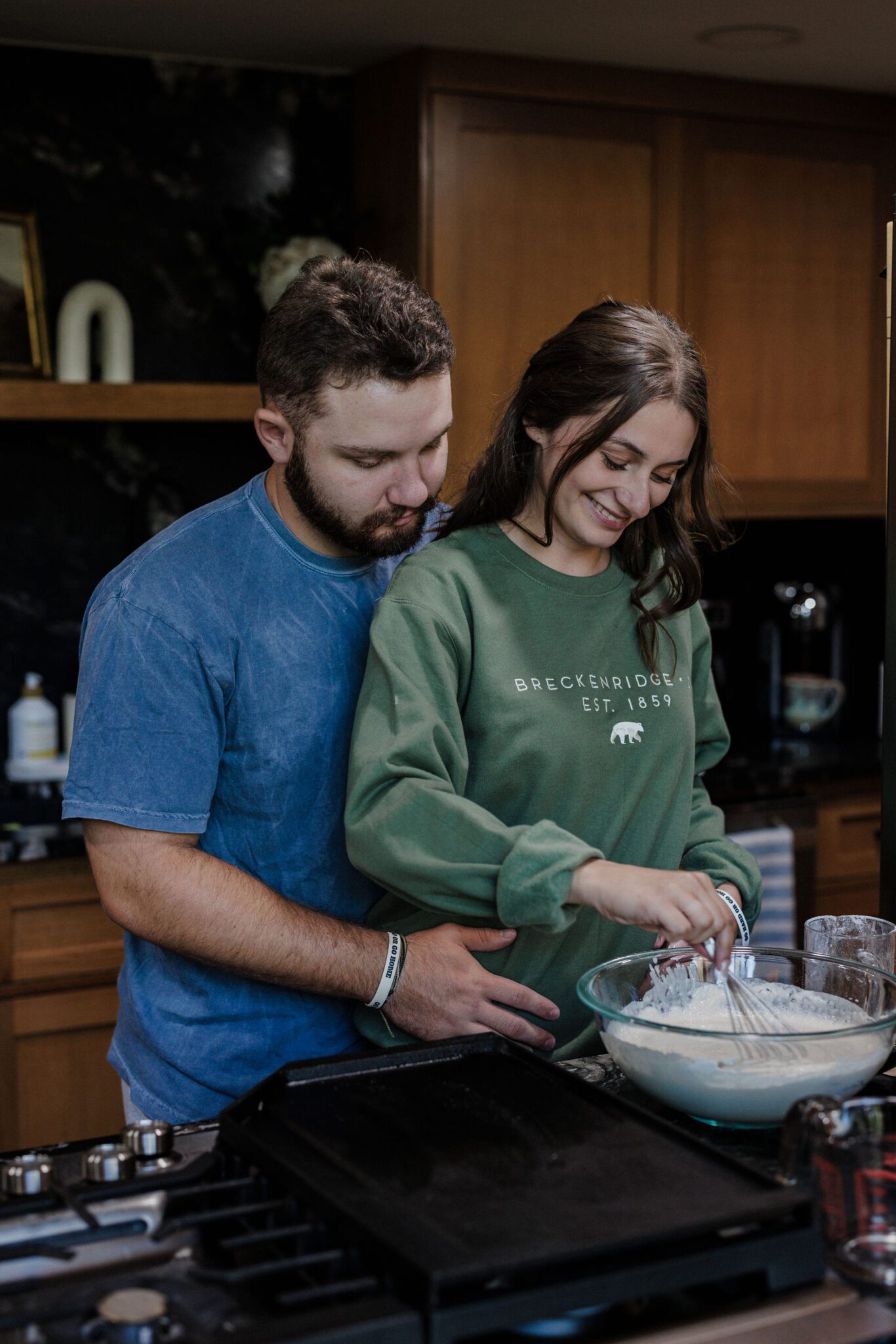 bride and groom make pancakes for their elopement morning