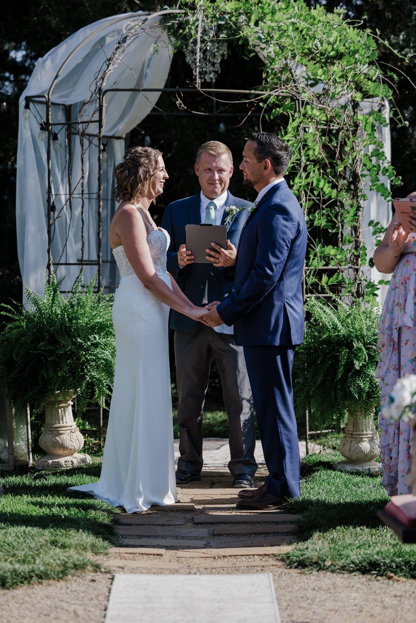 bride and groom stand at micro wedding and say wedding vows