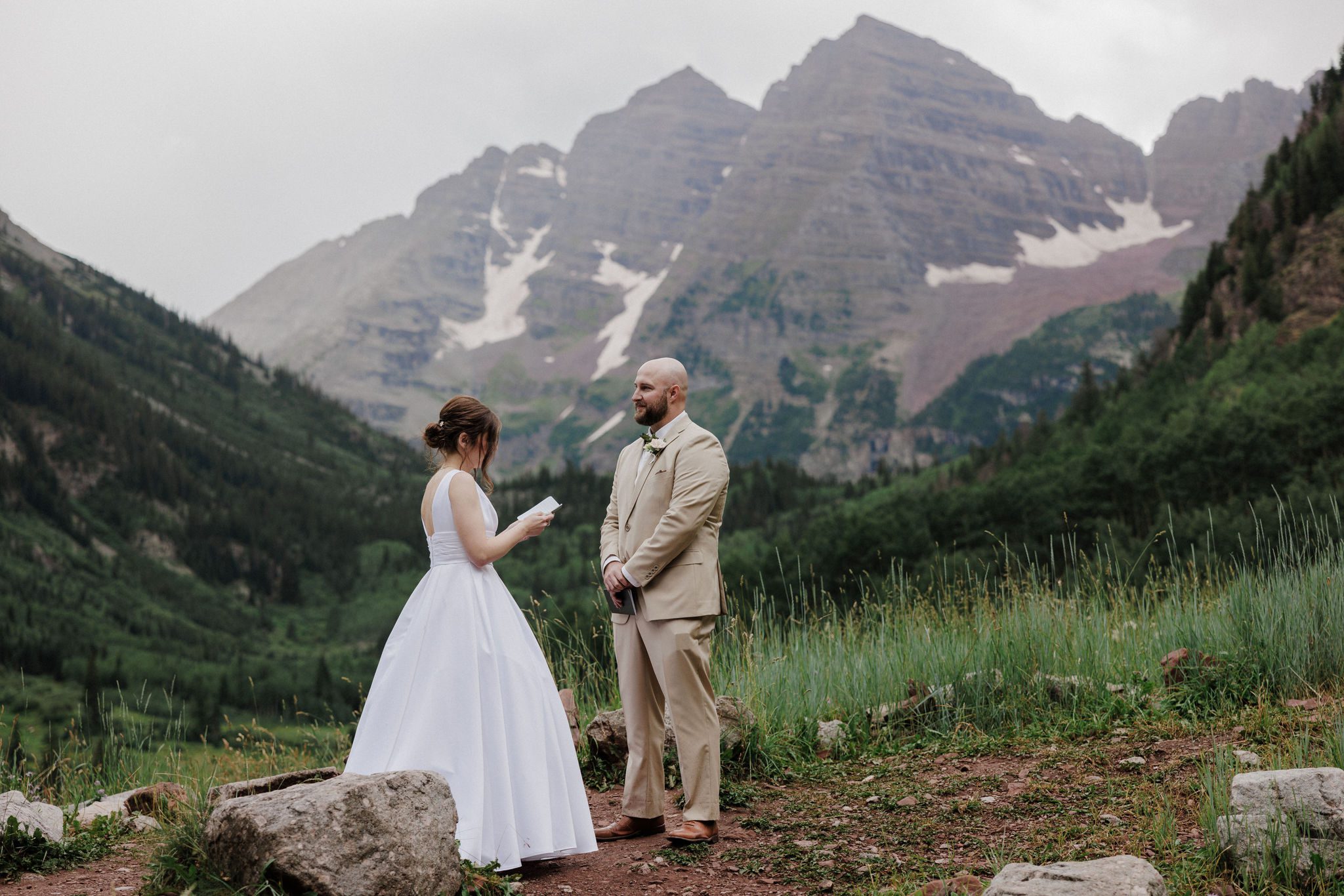 bride and groom read wedding vows at maroon bells