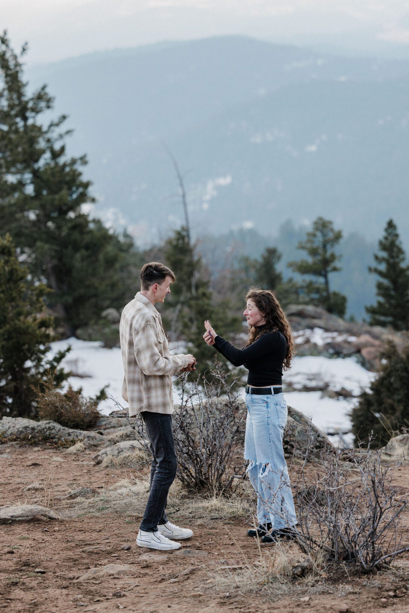 woman looks at ring after being proposed to in the best place in colorado, mt falcon