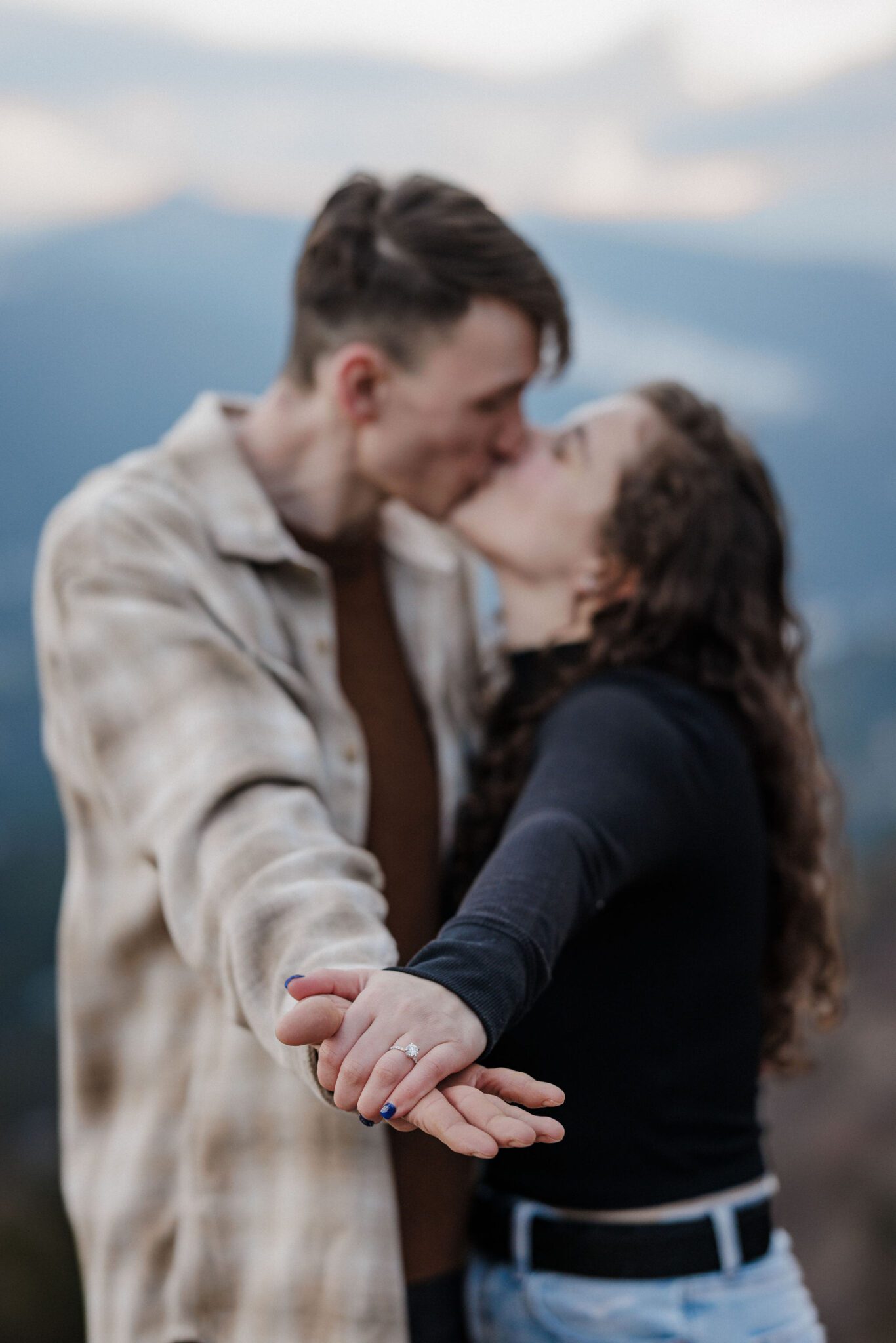 after choosing best place to propose in colorado, man and woman pose for photogrpaher in breckenridge