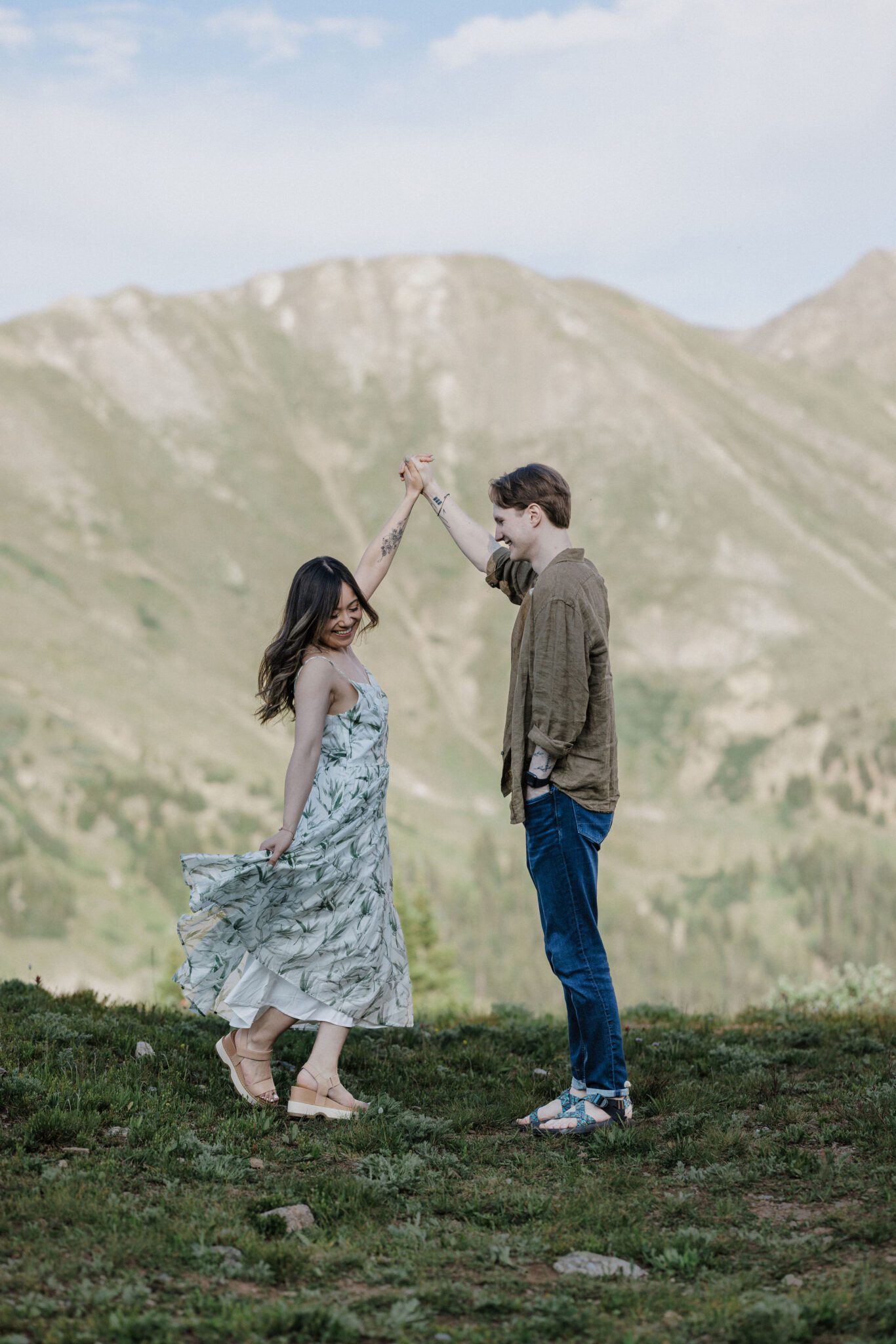 man twirls woman after choosing the best place to propose in colorado
