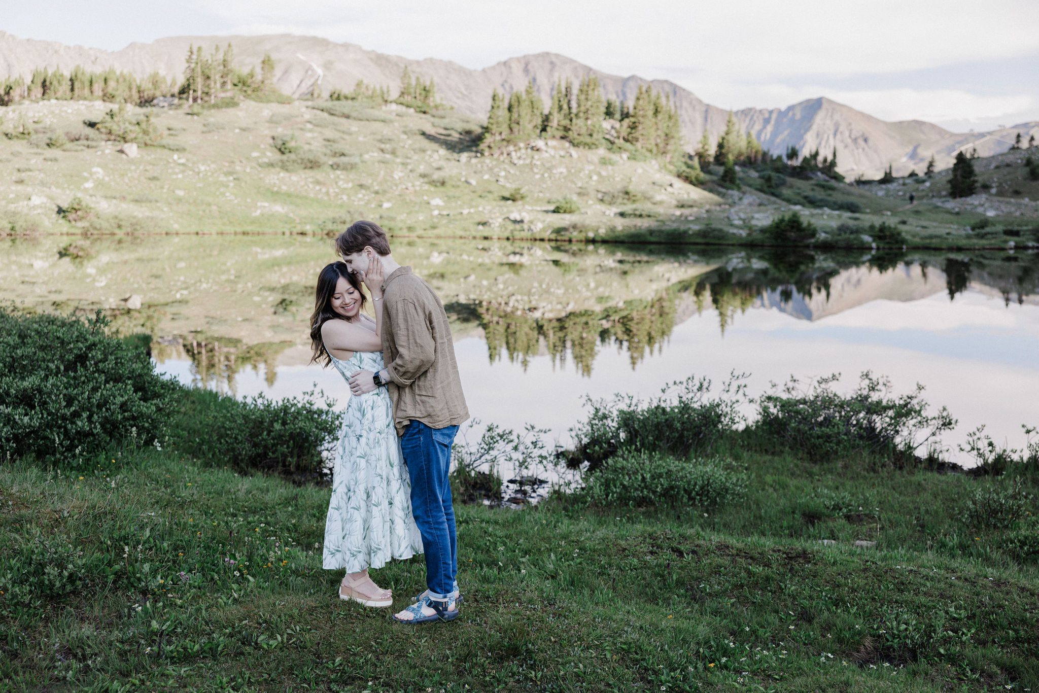 engaged couple poses for photographer at colorado proposal location