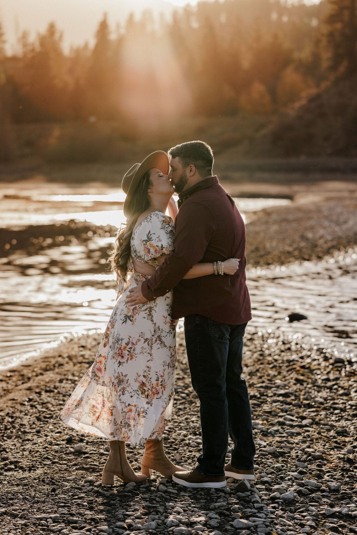 engaged couple kisses during sunset proposal photos
