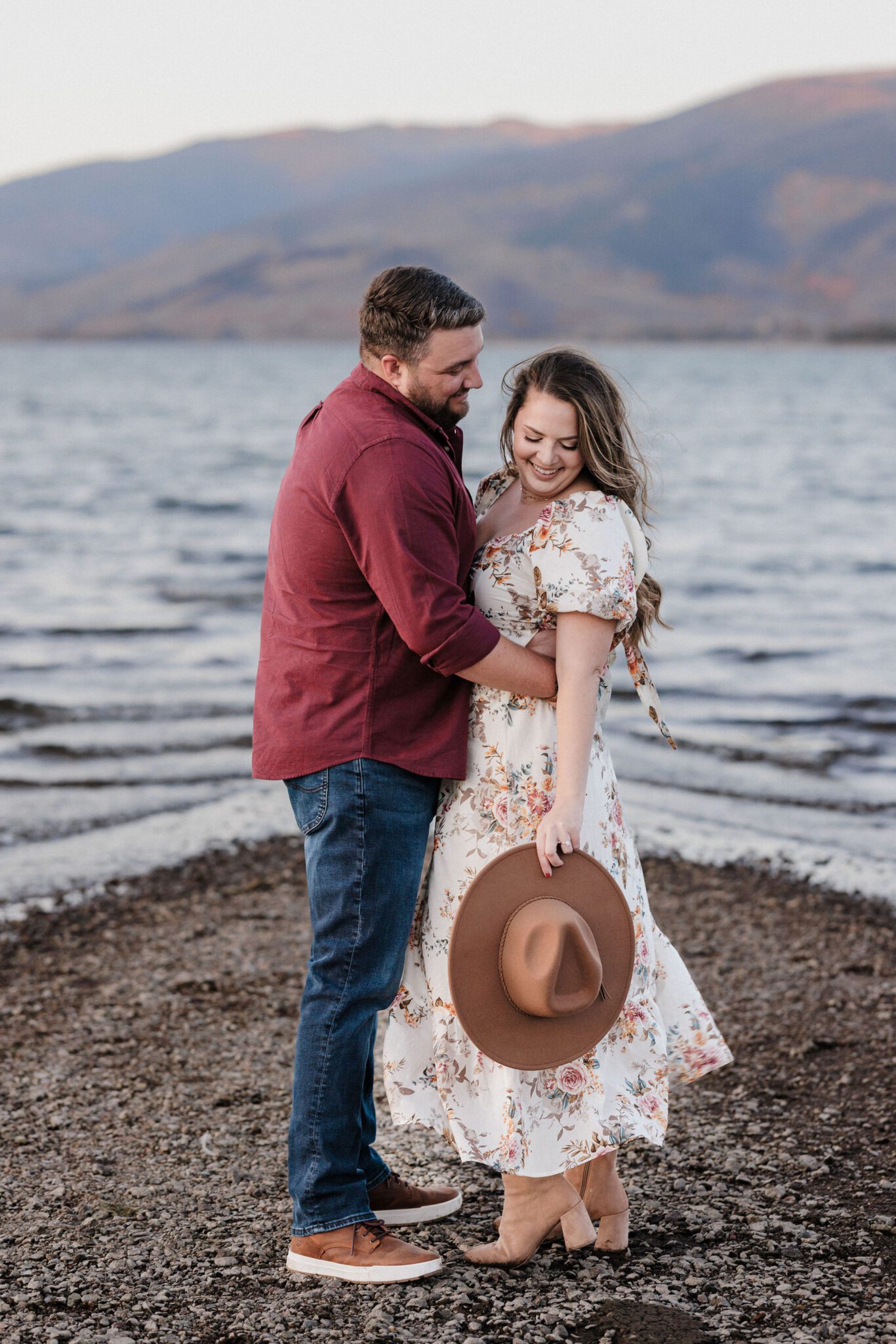 after choosing lake dillon as the best place to propose in colorado, engaged couple poses for photos