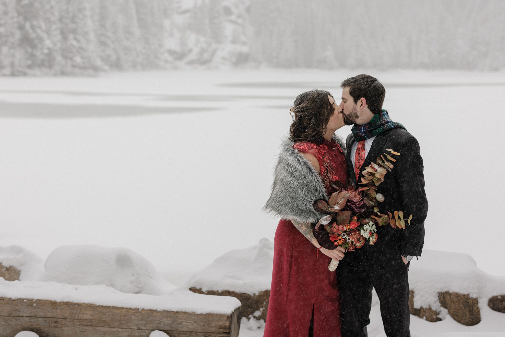 best places to propose in colorado: engaged couples kisses at rmnp
