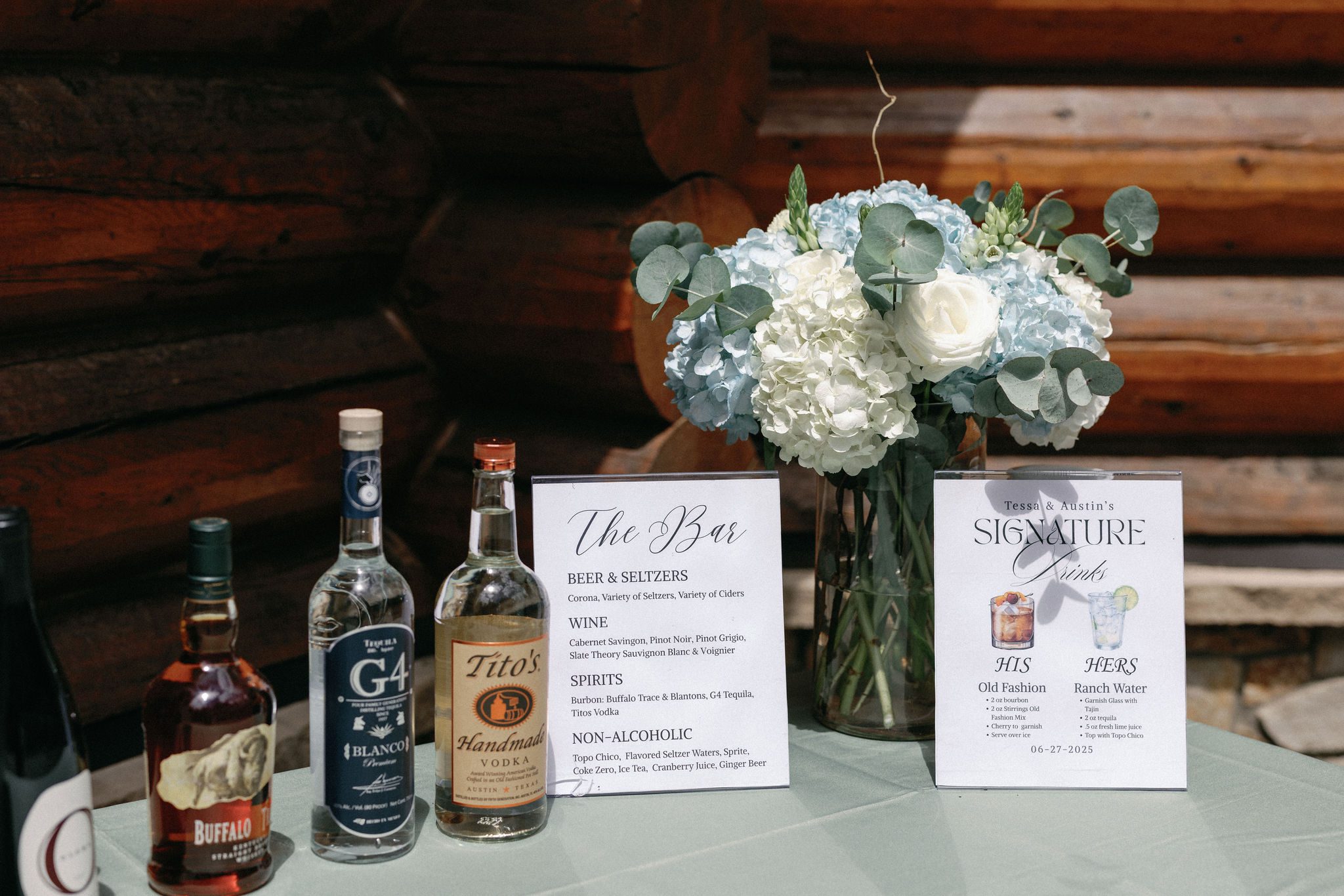 a cocktail table set up with his and hers drinks for a colorado airbnb wedding